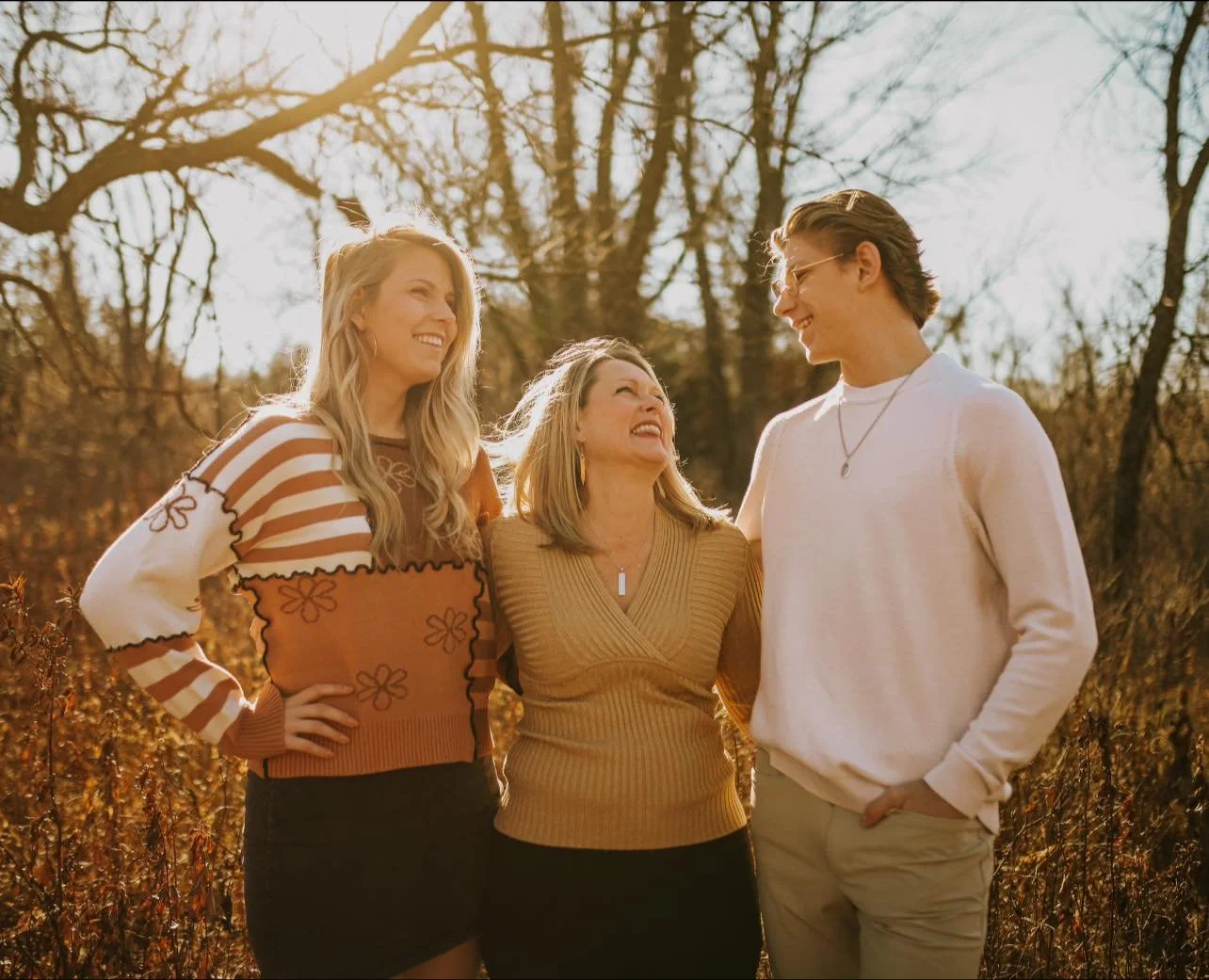 Paula Humbard with her two children outdoors.