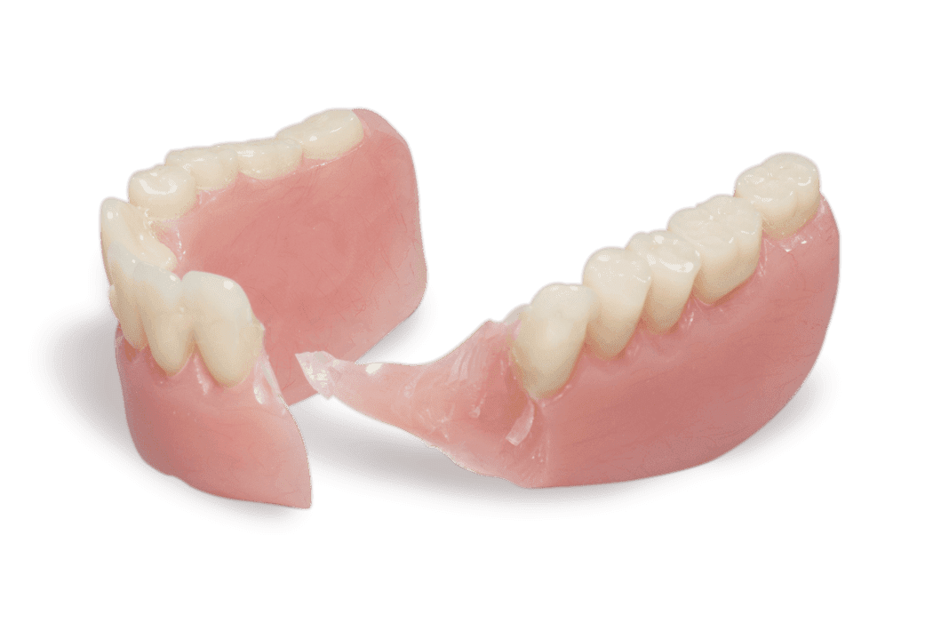 Broken set of dentures with missing teeth and a fall-apart piece.