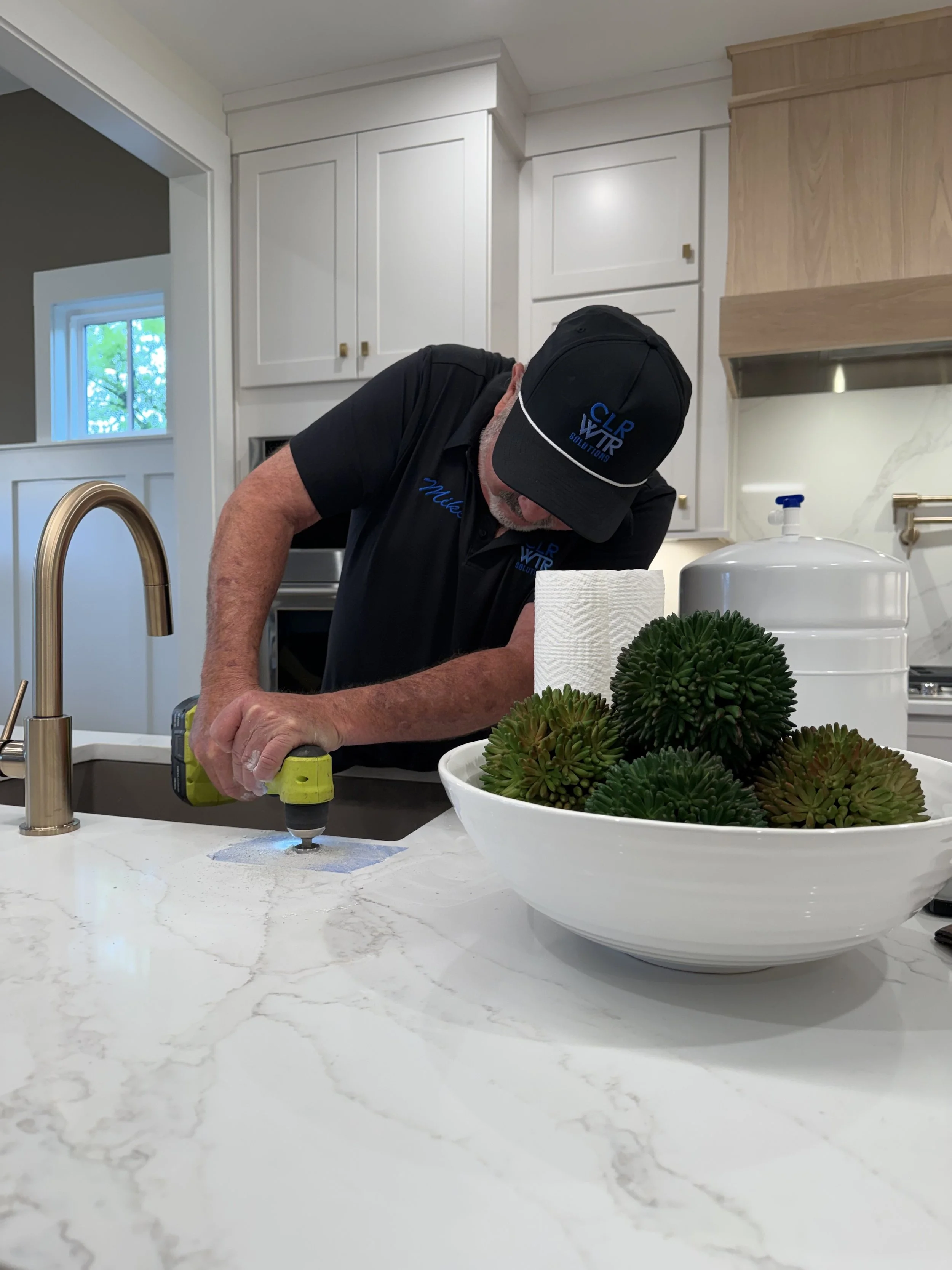 technician-installing-hydrogen-water-infuser-kitchen