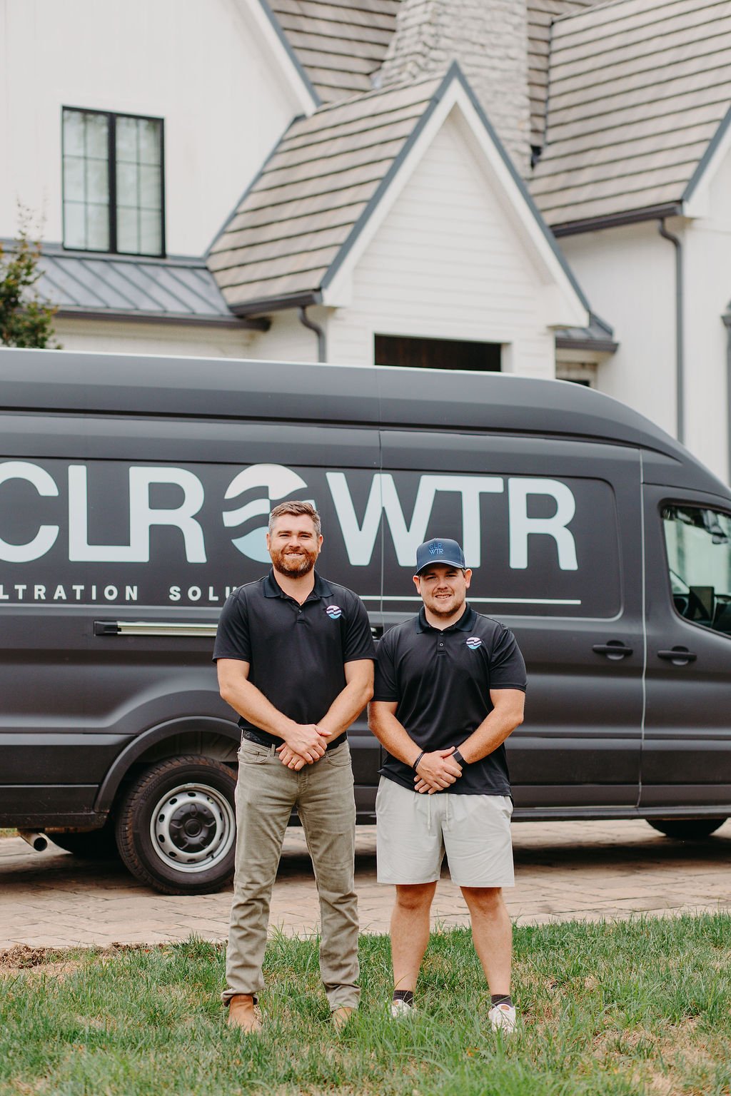 CLR WTR Solutions technicians standing in front of a branded installation truck
