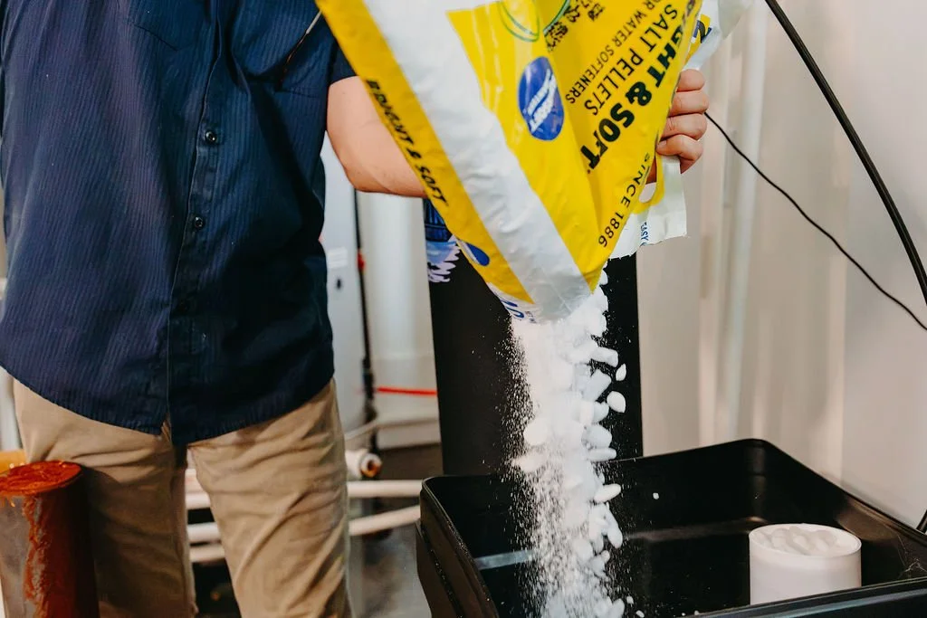 CLR WTR technician refilling salt in a commercial water softener