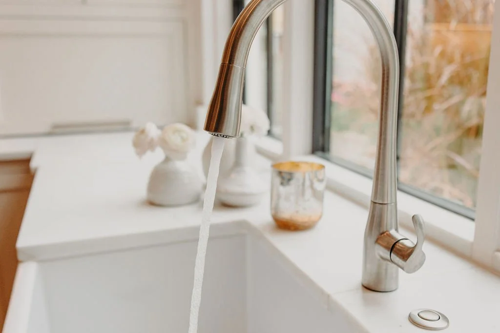 Clean water running from a kitchen faucet in a home