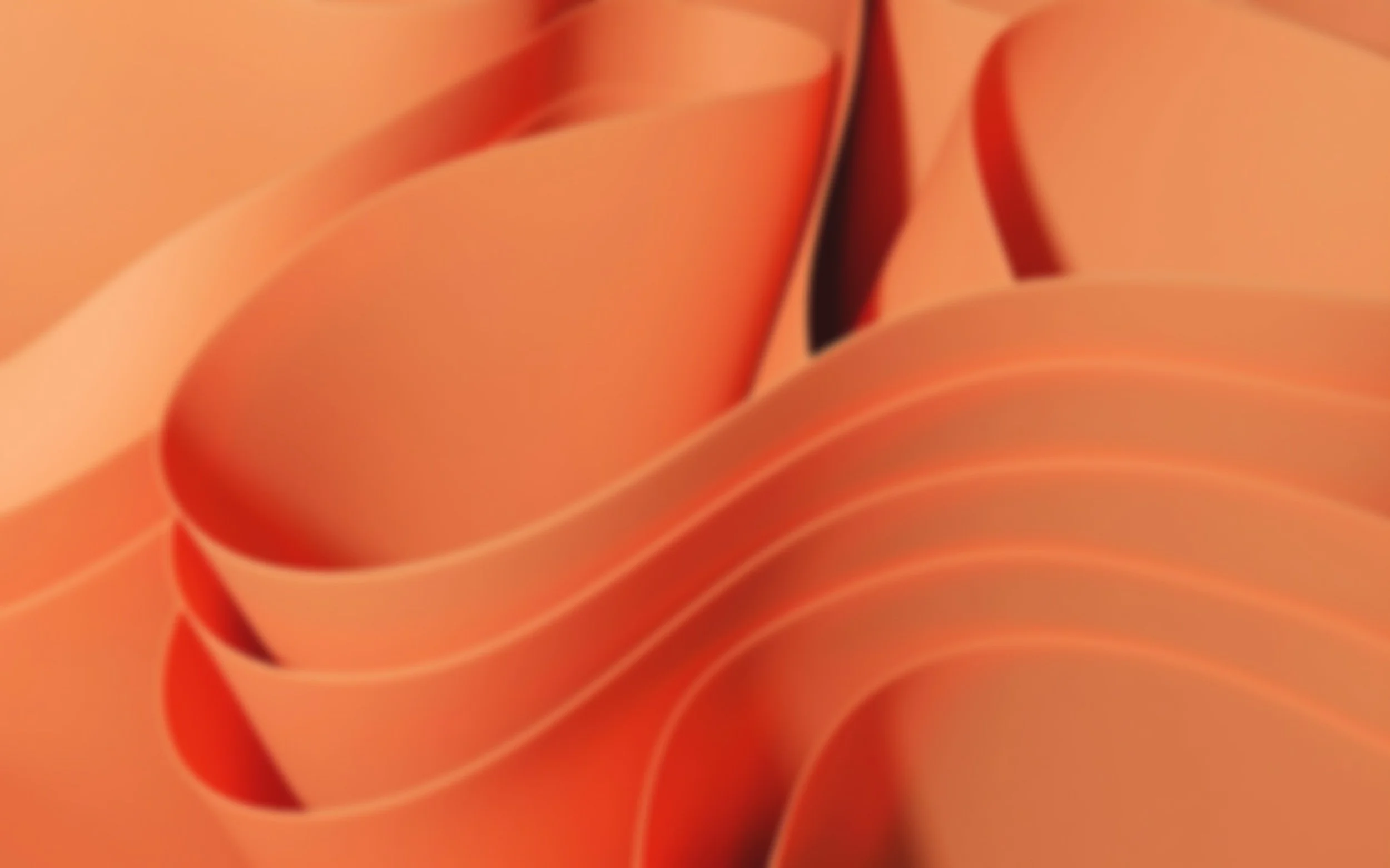 Close-up of stacked orange paper or plastic sheets with a curved, flowing arrangement.
