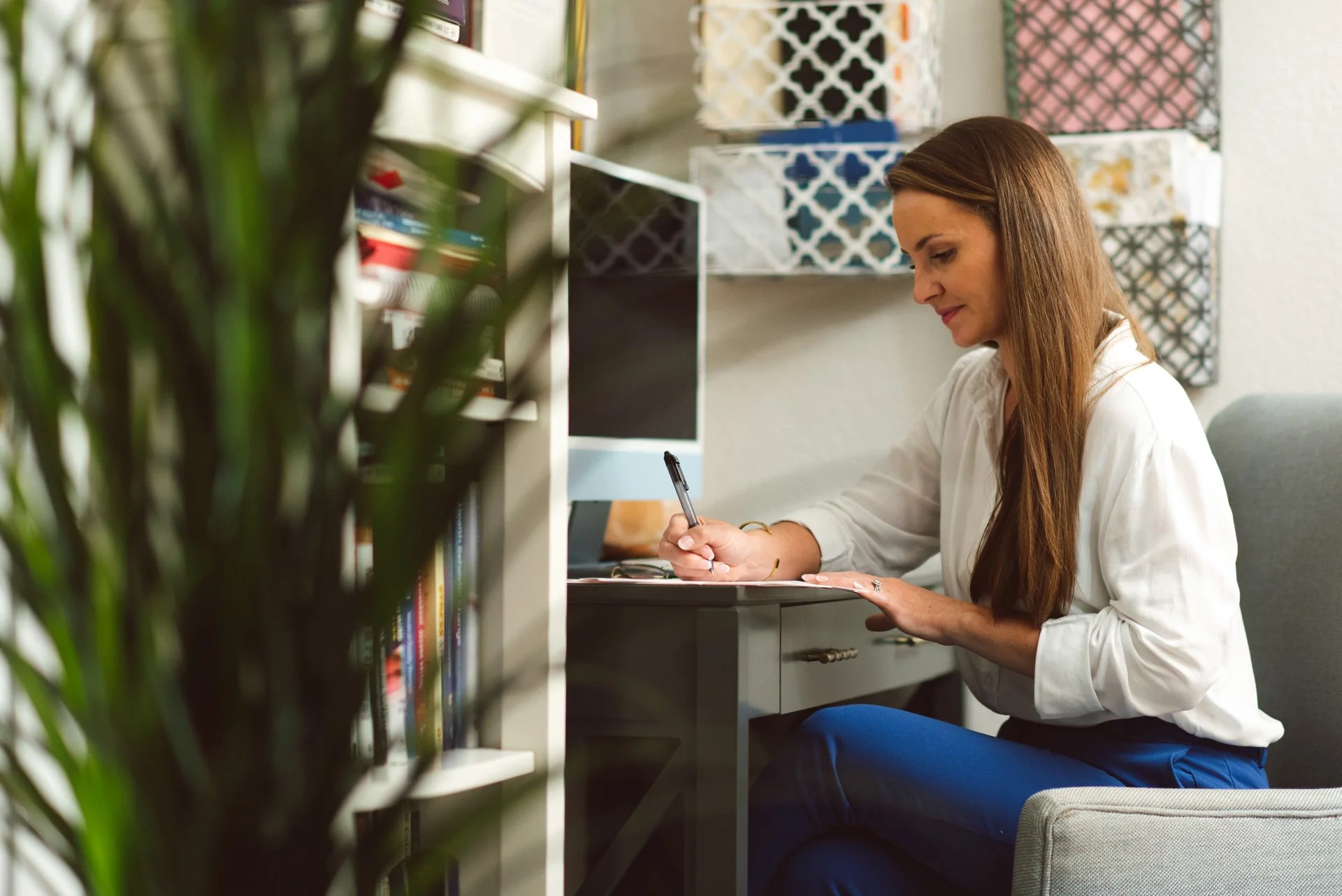 Dr. Nicole Biondoletti writing notes at her desk