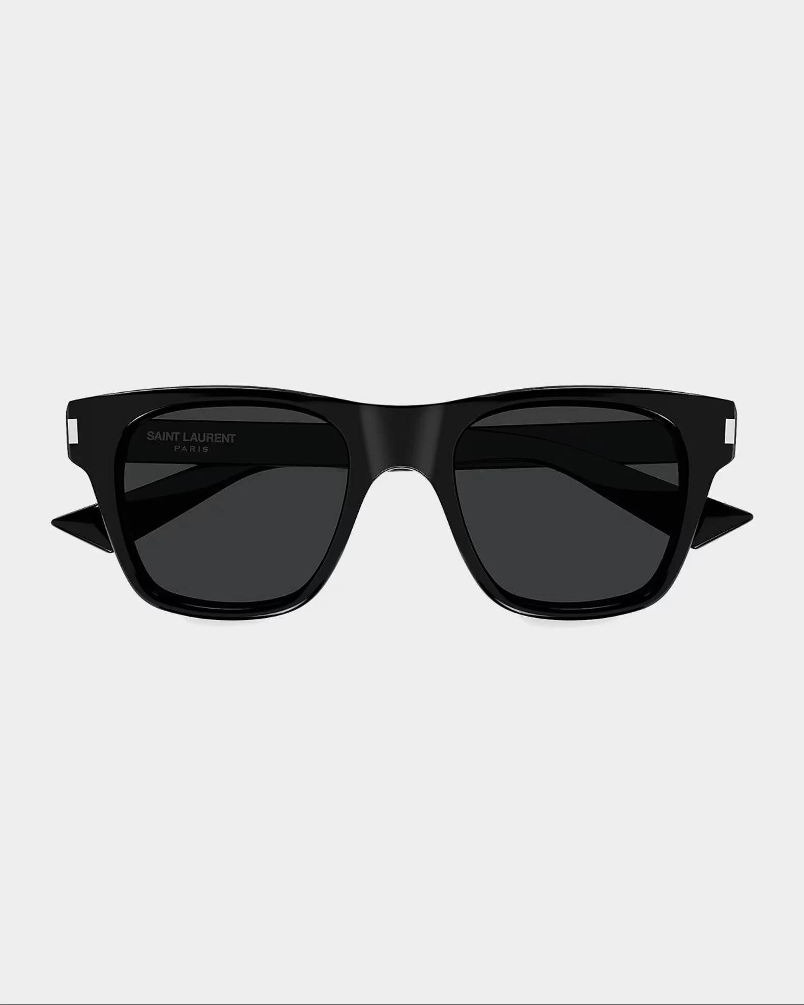 Black Saint Laurent Paris sunglasses with dark lenses on a gray background.