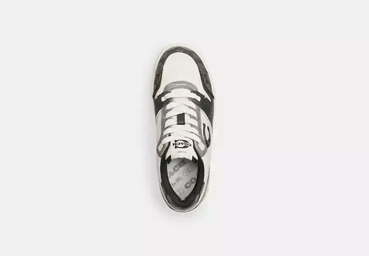 Top view of a black, white, and gray athletic shoe on a white background.