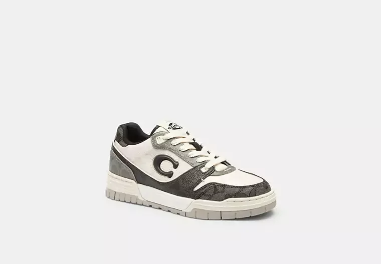 A black and white sneaker with a gray logo on the side.
