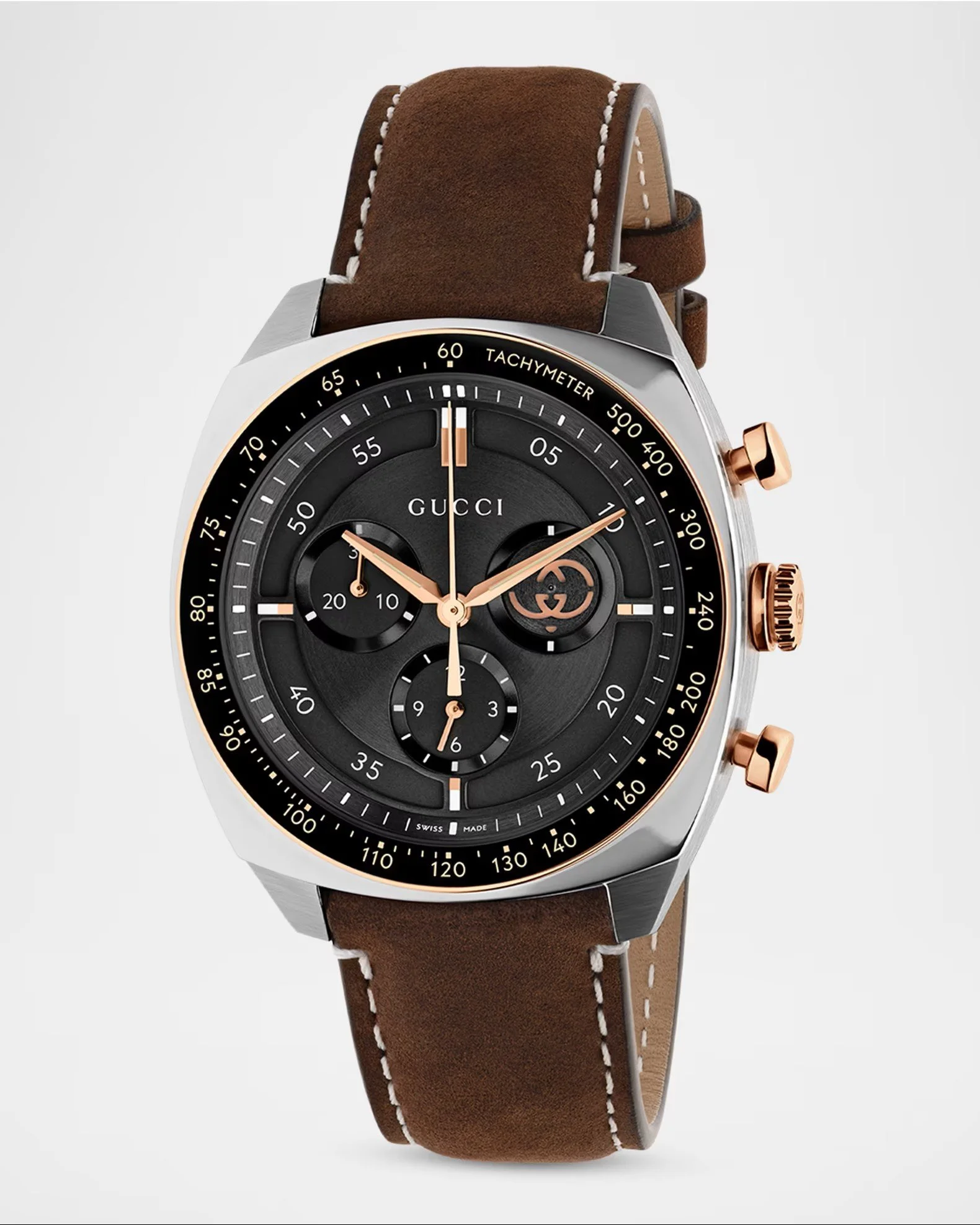 Close-up of a luxury men's wristwatch with a black face, gold accents, and a brown leather strap.