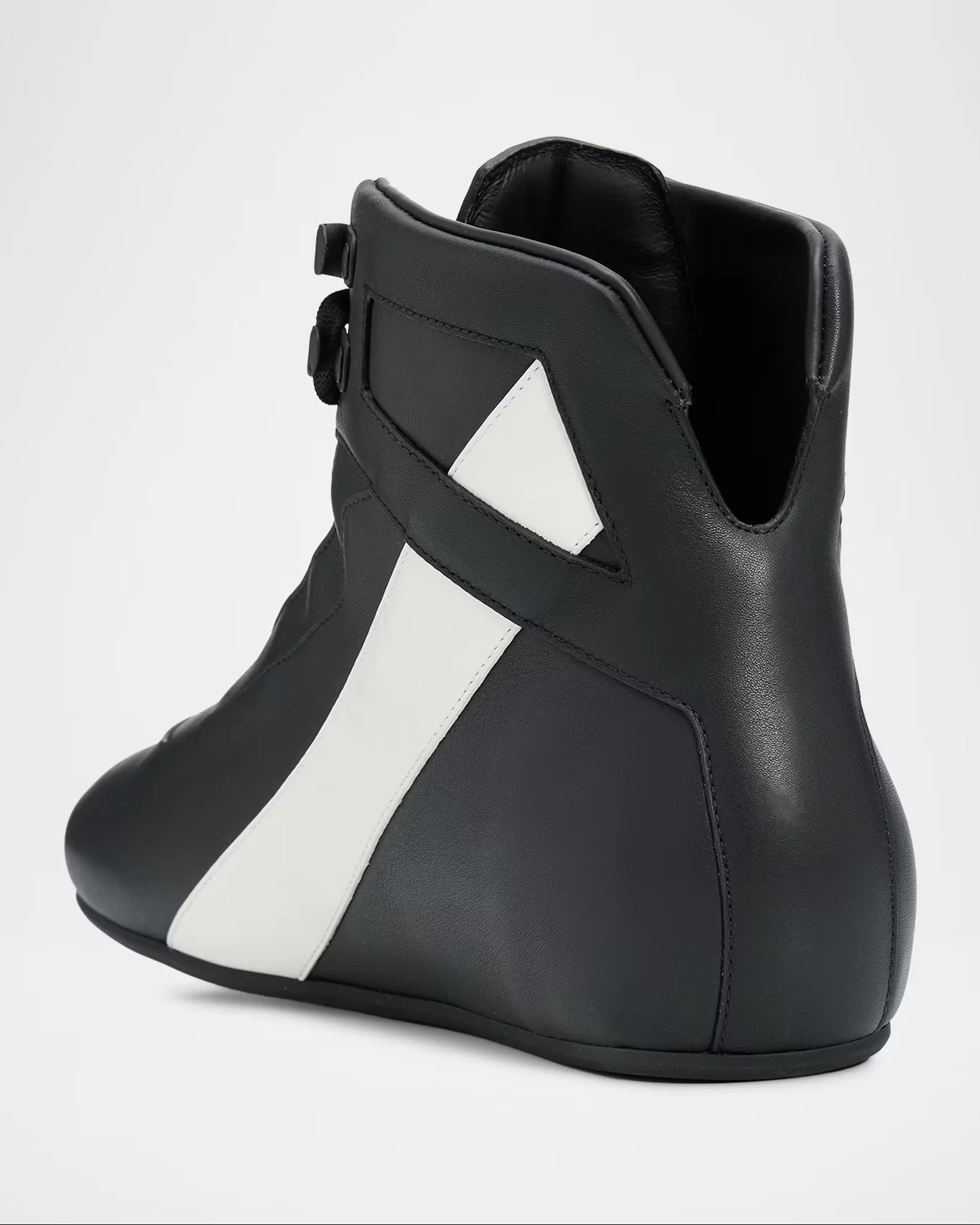 A black and white sneaker with a high-top design, black base with white stripe detail, and black sole, displayed against a plain white background.