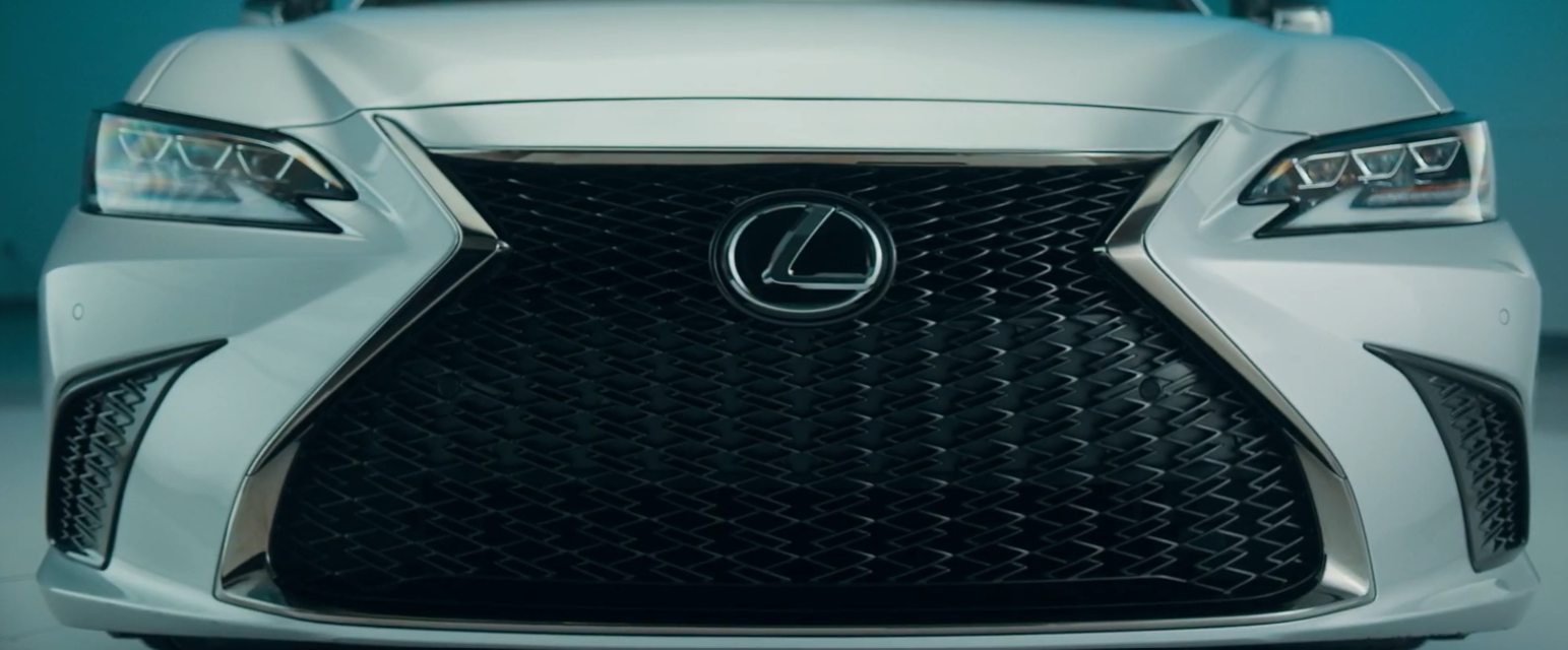 Front view of a white Lexus car showing the grille and headlights.