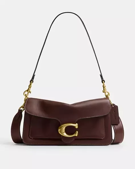 A brown leather shoulder bag with a gold clasp and a black and gold strap.