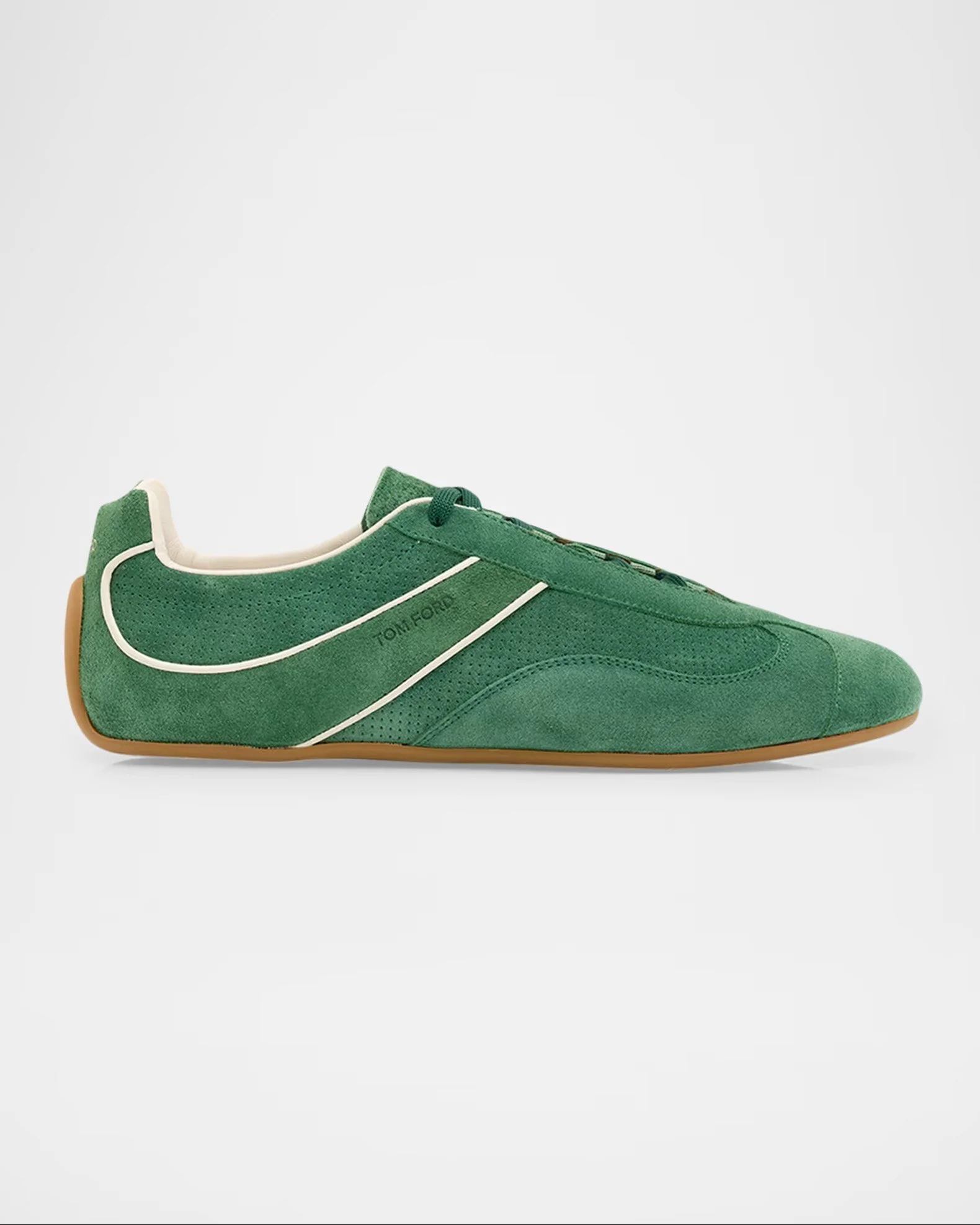 Close-up of a green athletic shoe with white accents and a gum sole, featuring a sleek design for sports or casual wear.