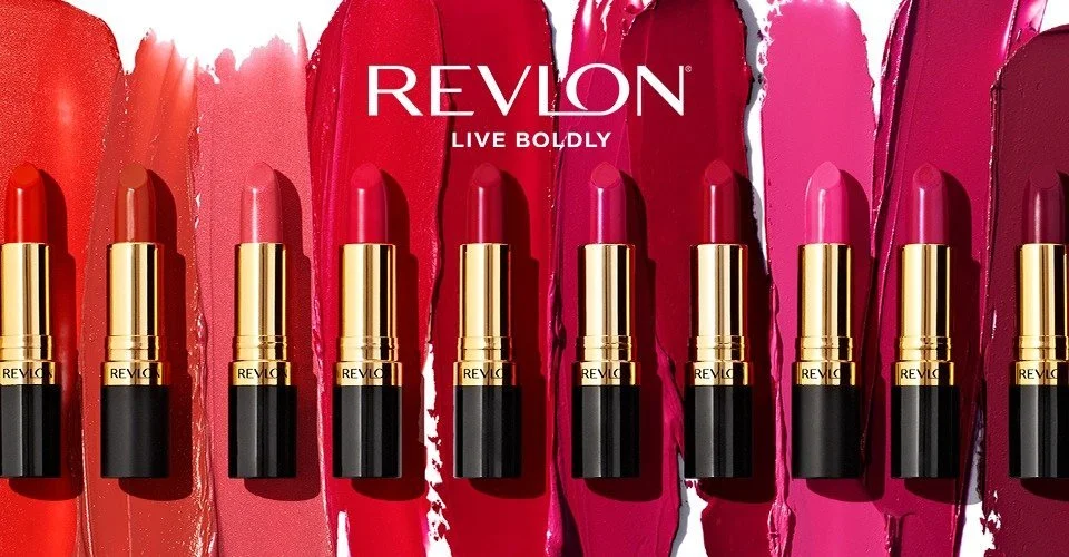 Various shades of Revlon lipsticks arranged in a row with color swatches behind each lipstick, and the Revlon logo at the top.