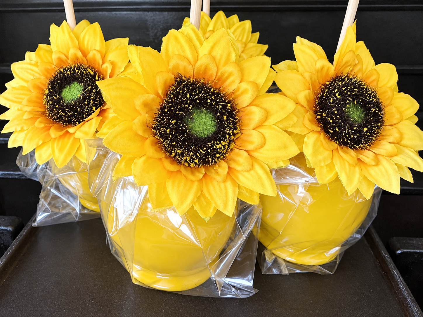 Yellow candy apples decorated for a sunflower theme by Sugar Sweets by Peeks.