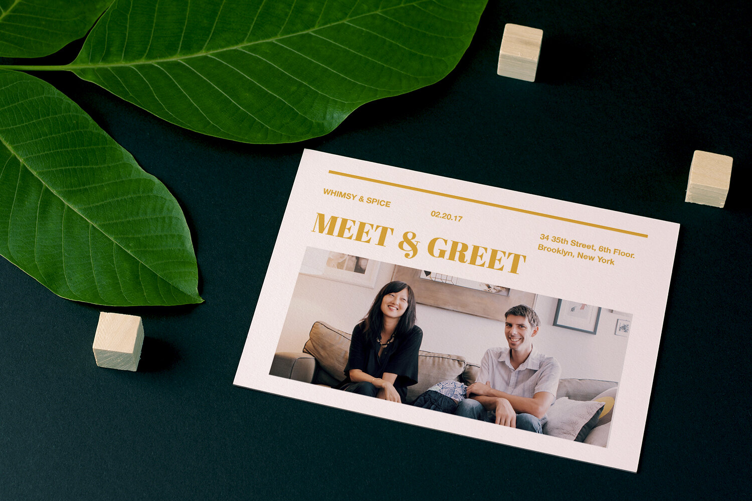 Printed postcard mockup styled on a dark surface with foliage, showing a meet and greet event design