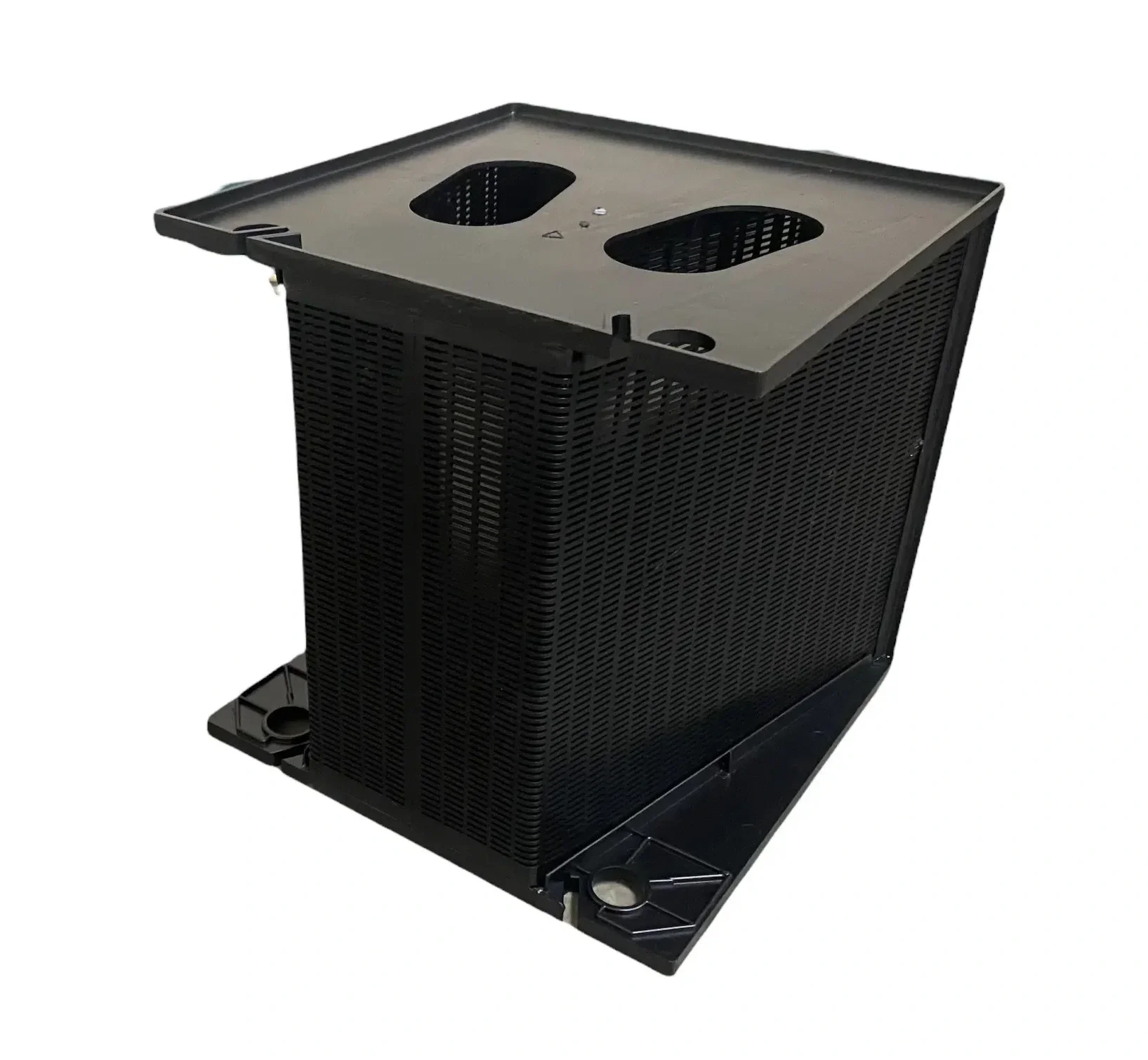A black electronic device with a square top, perforated sides, and a metal panel on the top surface with oval cutouts.