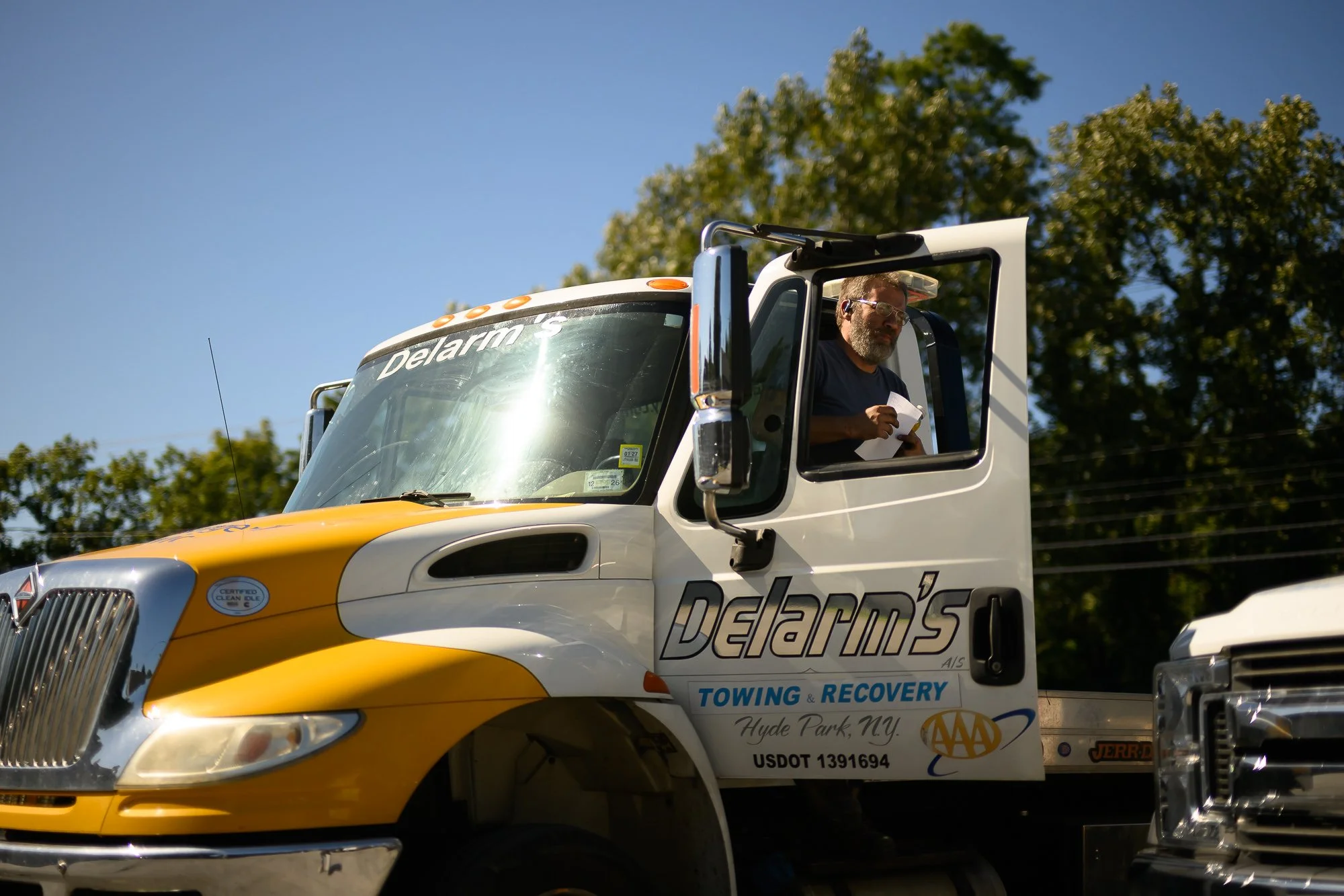 John at the wheel of a Delarm's tow truck