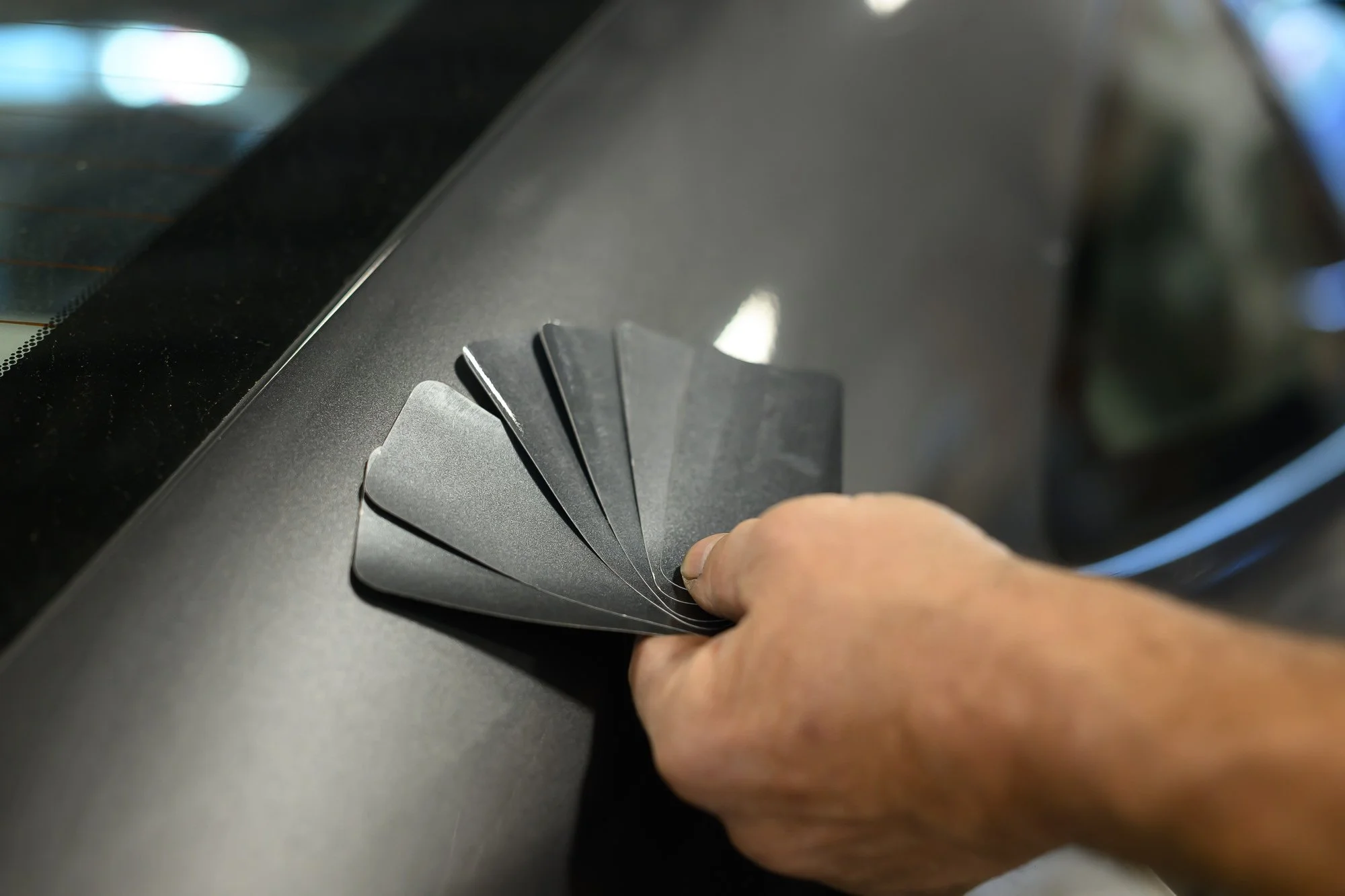 Matching a car's paint color with a fan of paint chip samples