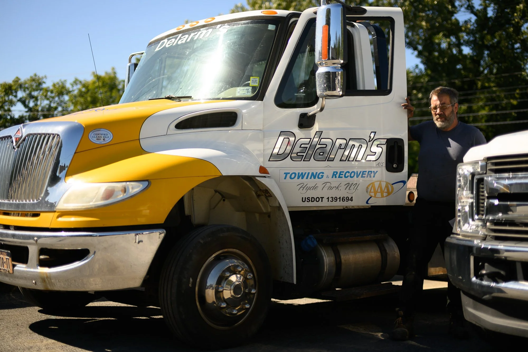 John standing beside a Delarm's tow truck
