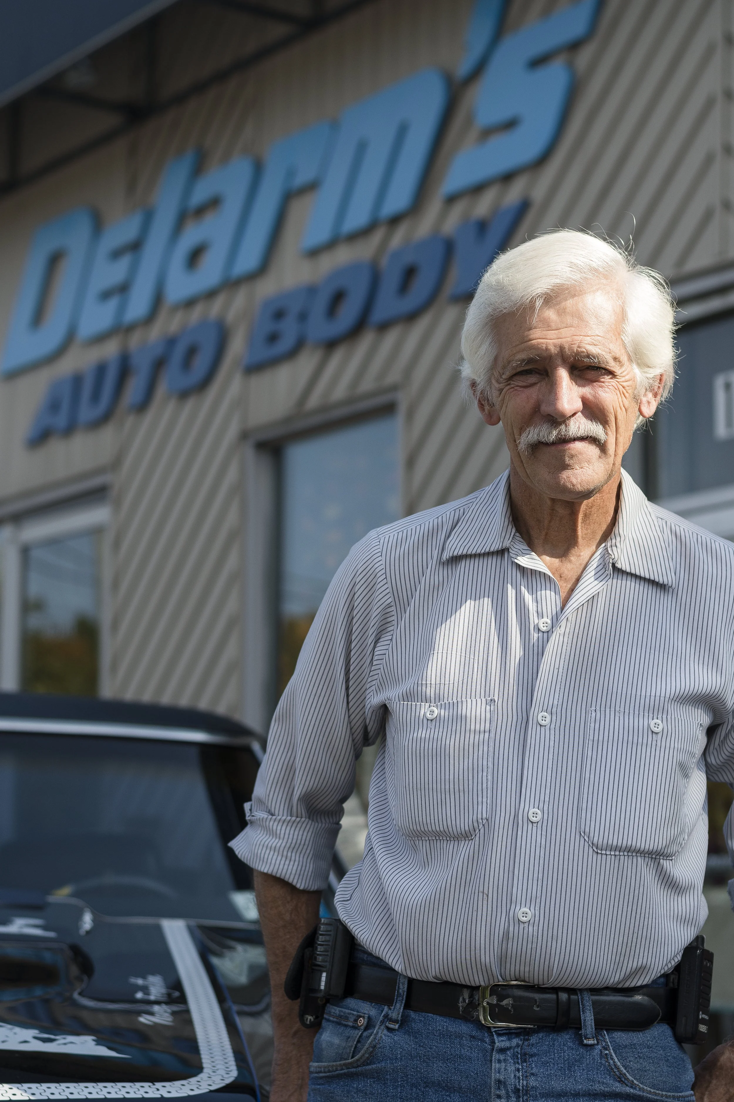 Bob of Delarm's Auto outside the shop