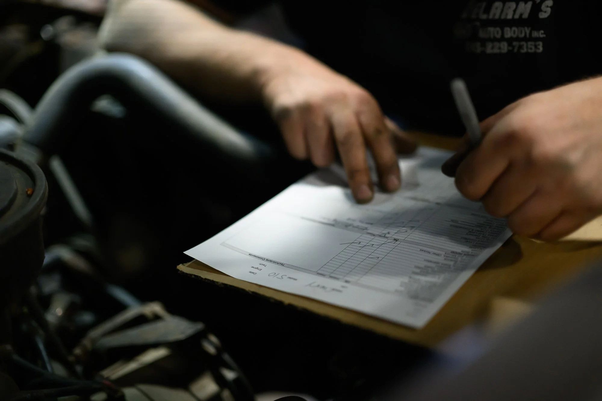 Filling out repair paperwork on a clipboard