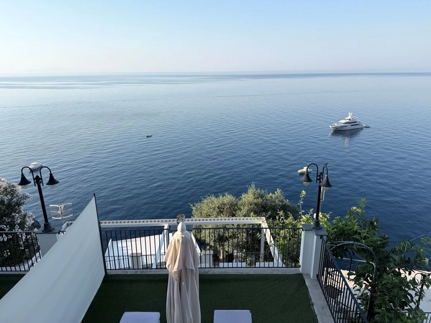 View of the Mediterranean Sea and yachts from a boutique hotel terrace in Praiano on Italy's Amalfi Coast.