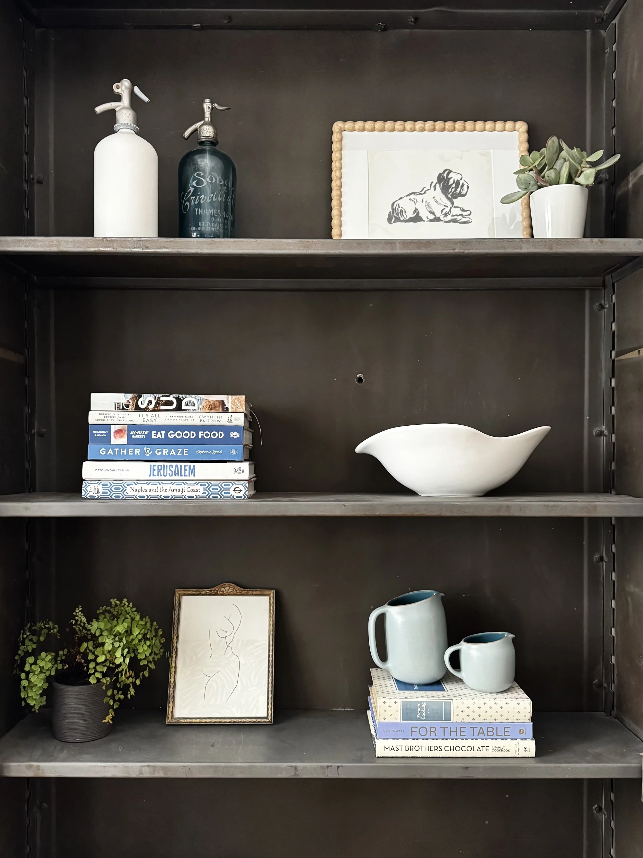 Styled kitchen shelving in a San Anselmo home, featuring curated art, books, plants and ceramics, showcasing thoughtful interior styling and approachable interior design by Aster & Aire in Marin County.