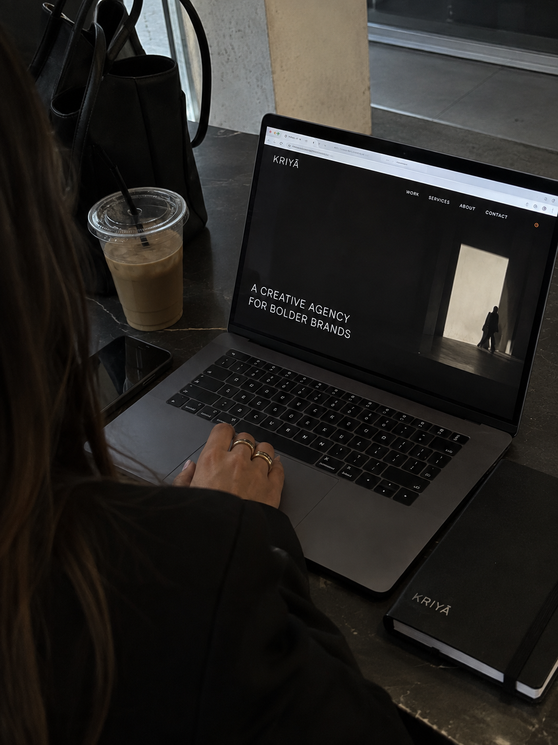Profissional da Kriyā Projects a trabalhar num portátil durante o desenvolvimento de estratégia e comunicação de marca.