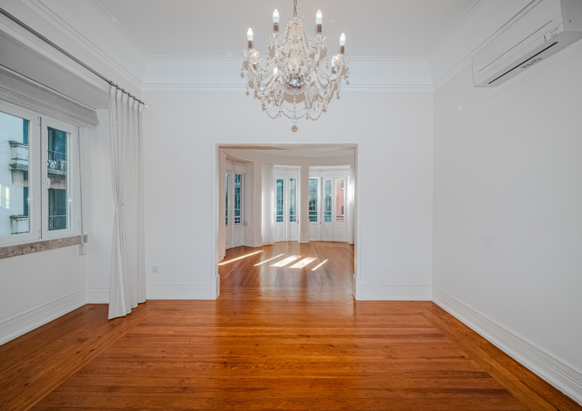 Central framing emphasises symmetry, depth and the transition between rooms.