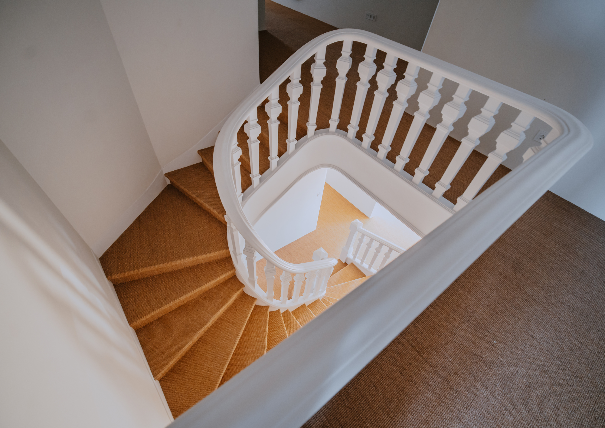 Top-down framing highlights the staircase geometry and flow between levels.