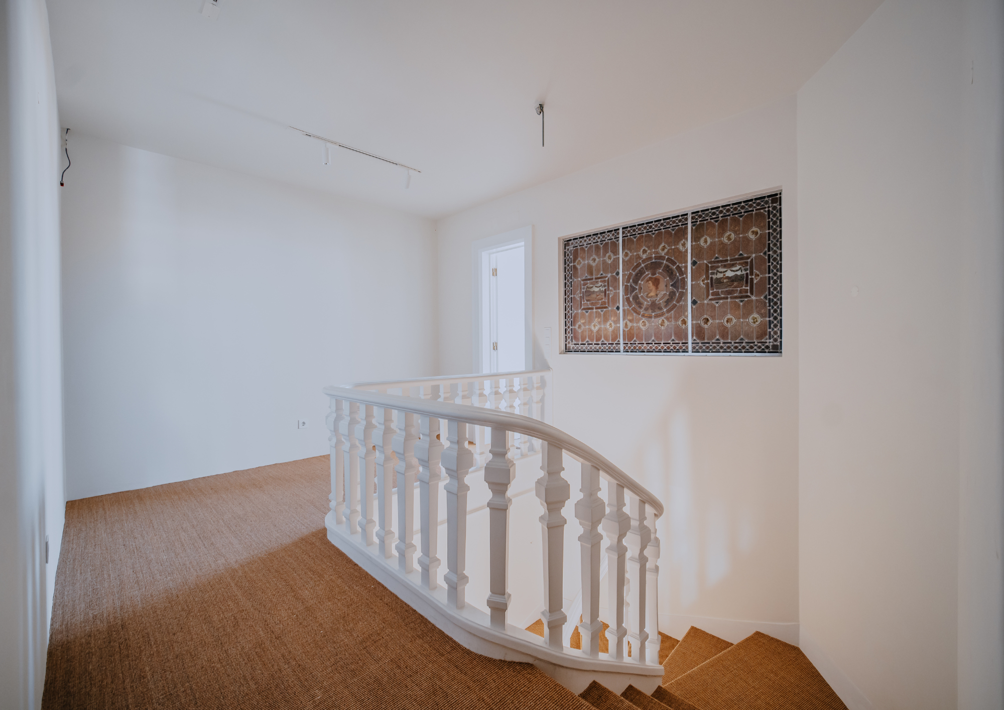 Framed to balance the curved staircase with the home’s original architectural detail.