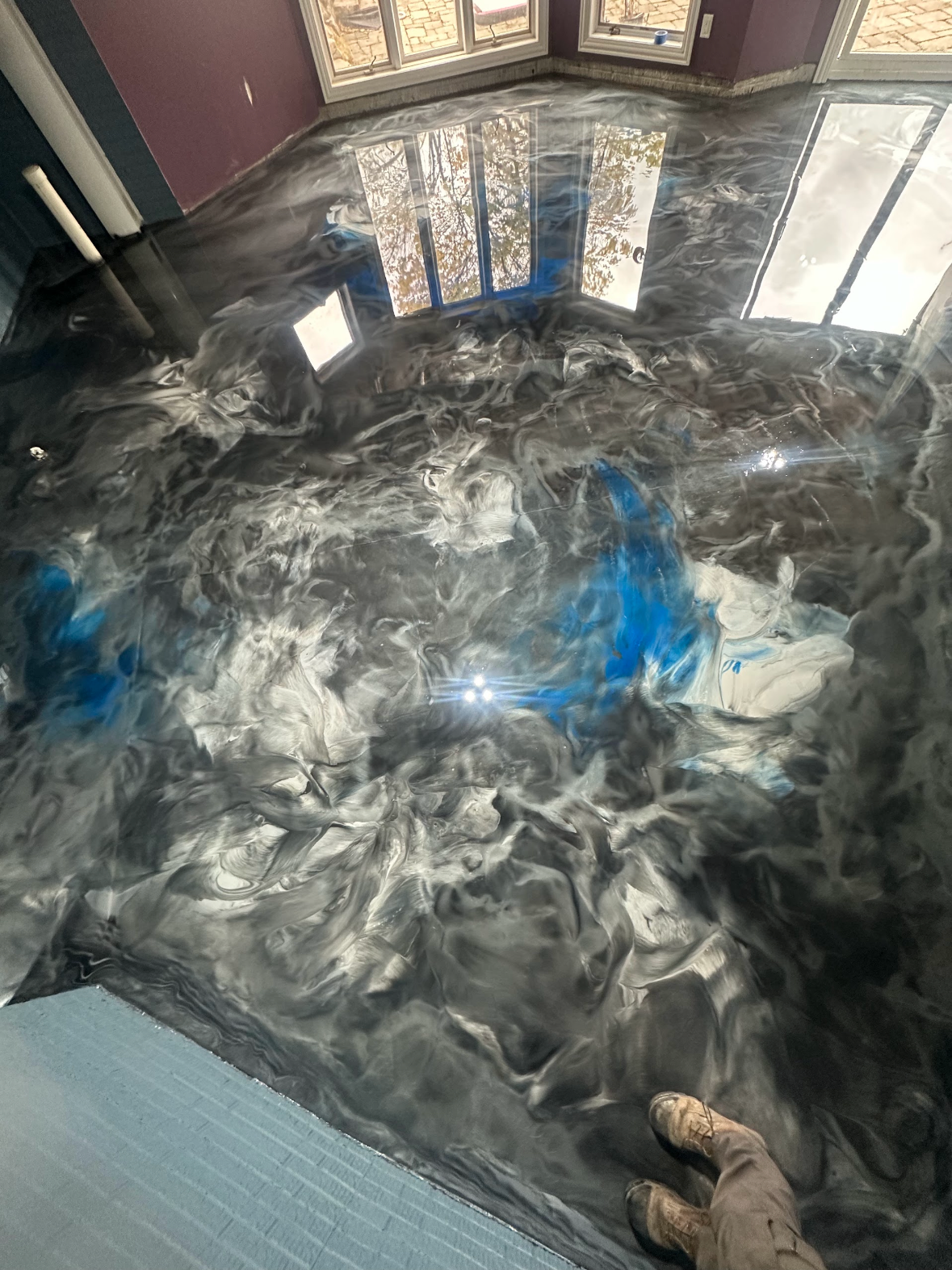 Custom white, gray, black metallic epoxy inside basement
