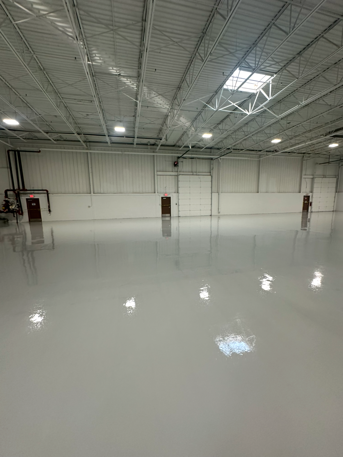 Light gray solid color epoxy inside a large warehouse