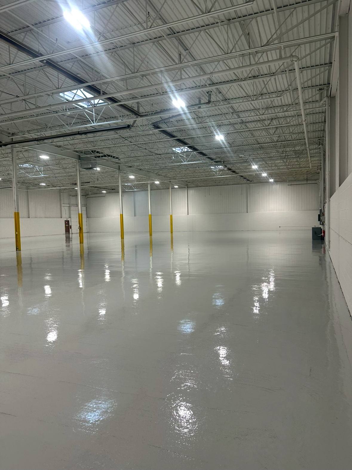 Light gray solid color epoxy inside a large warehouse