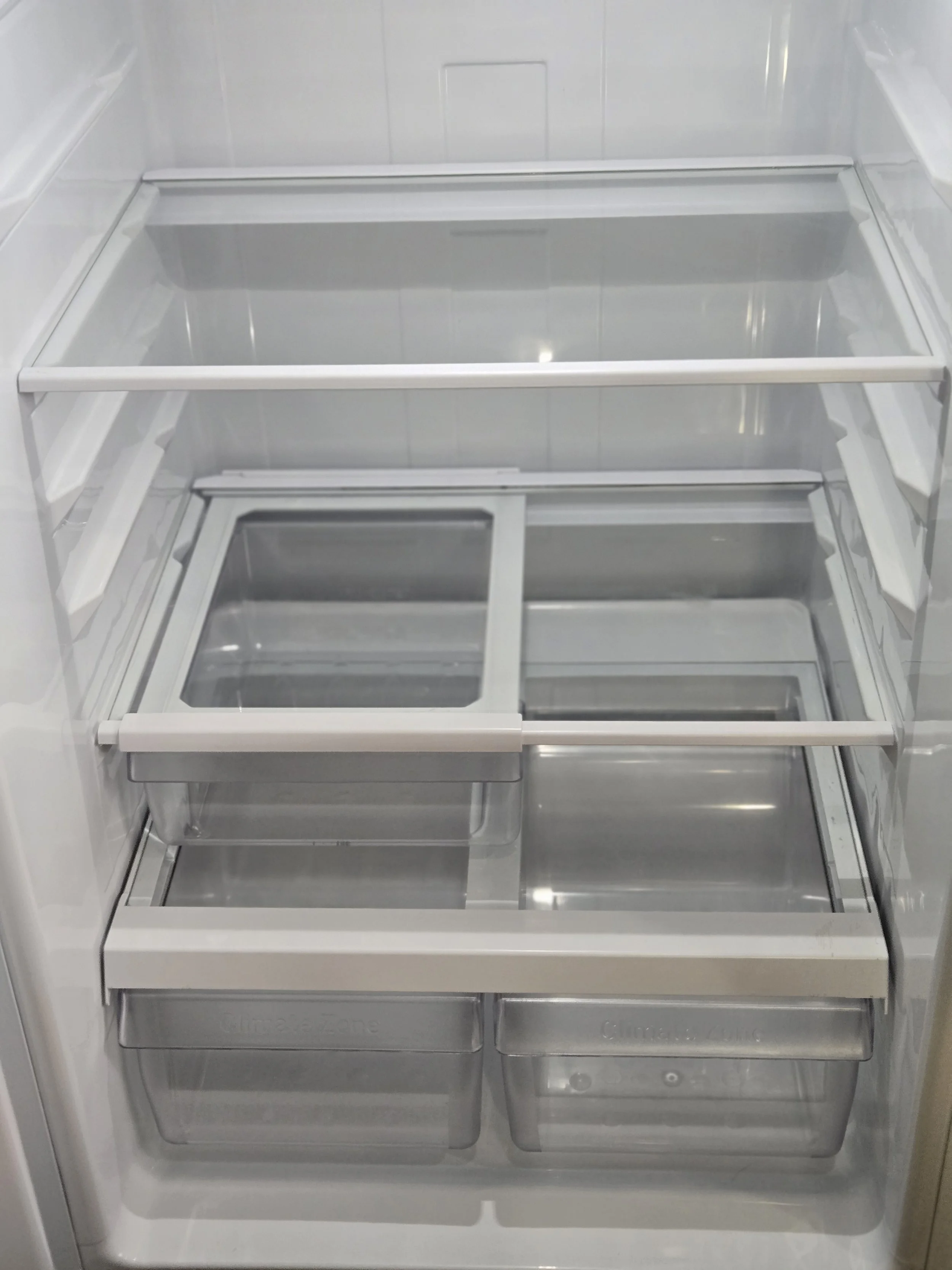Empty refrigerator with no food inside.