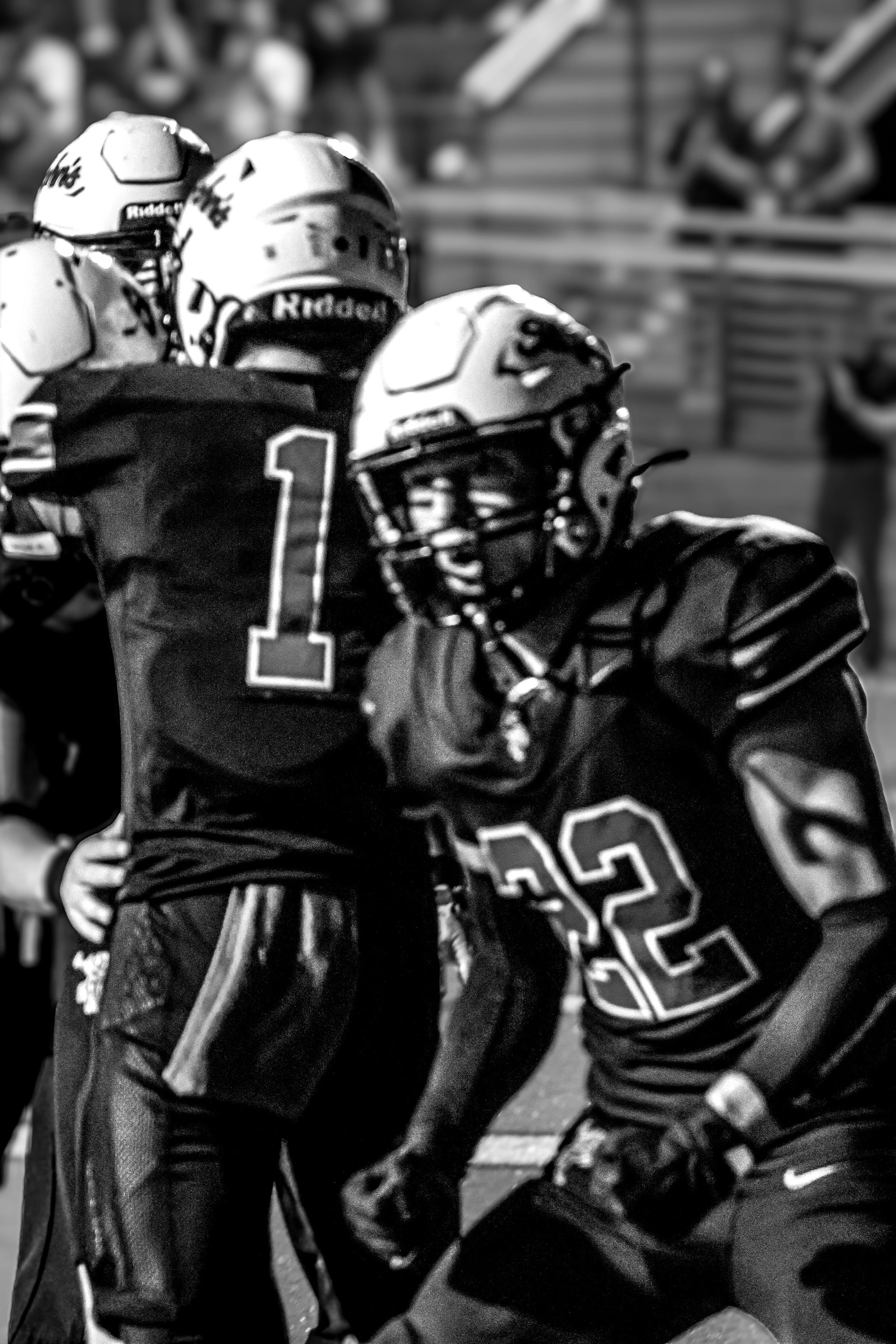 American football players on the field, one with the number 1 jersey and another with the number 22 jersey.