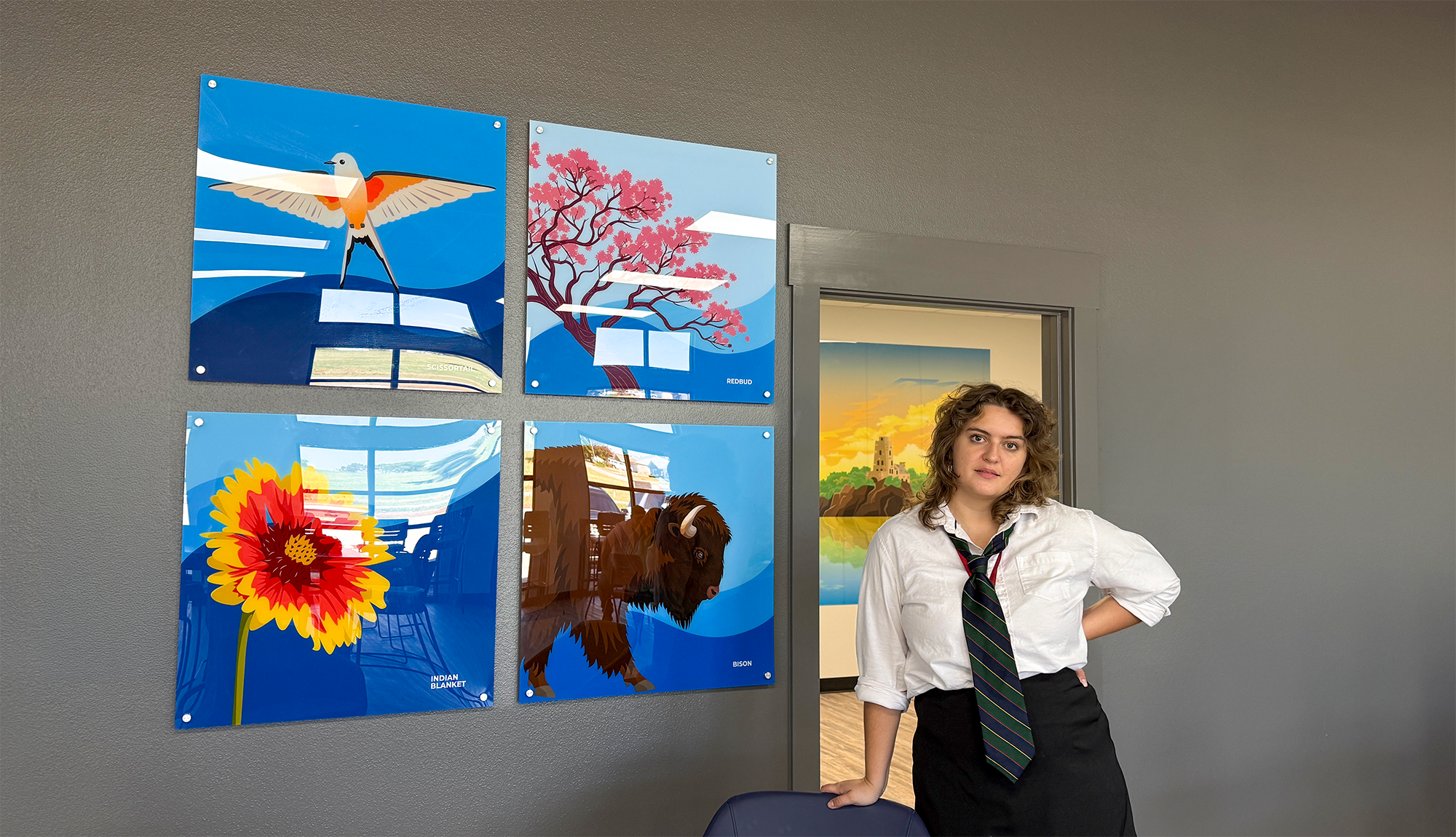 Young woman stands in front of art.