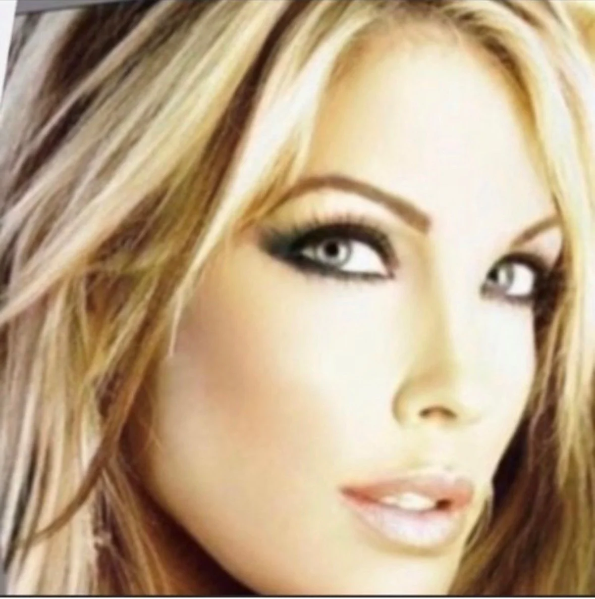 Close-up of a woman's face with blonde hair and makeup, looking at the camera.