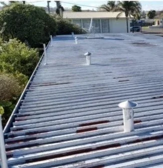 Metal commercial roof showing areas requiring restoration and repair