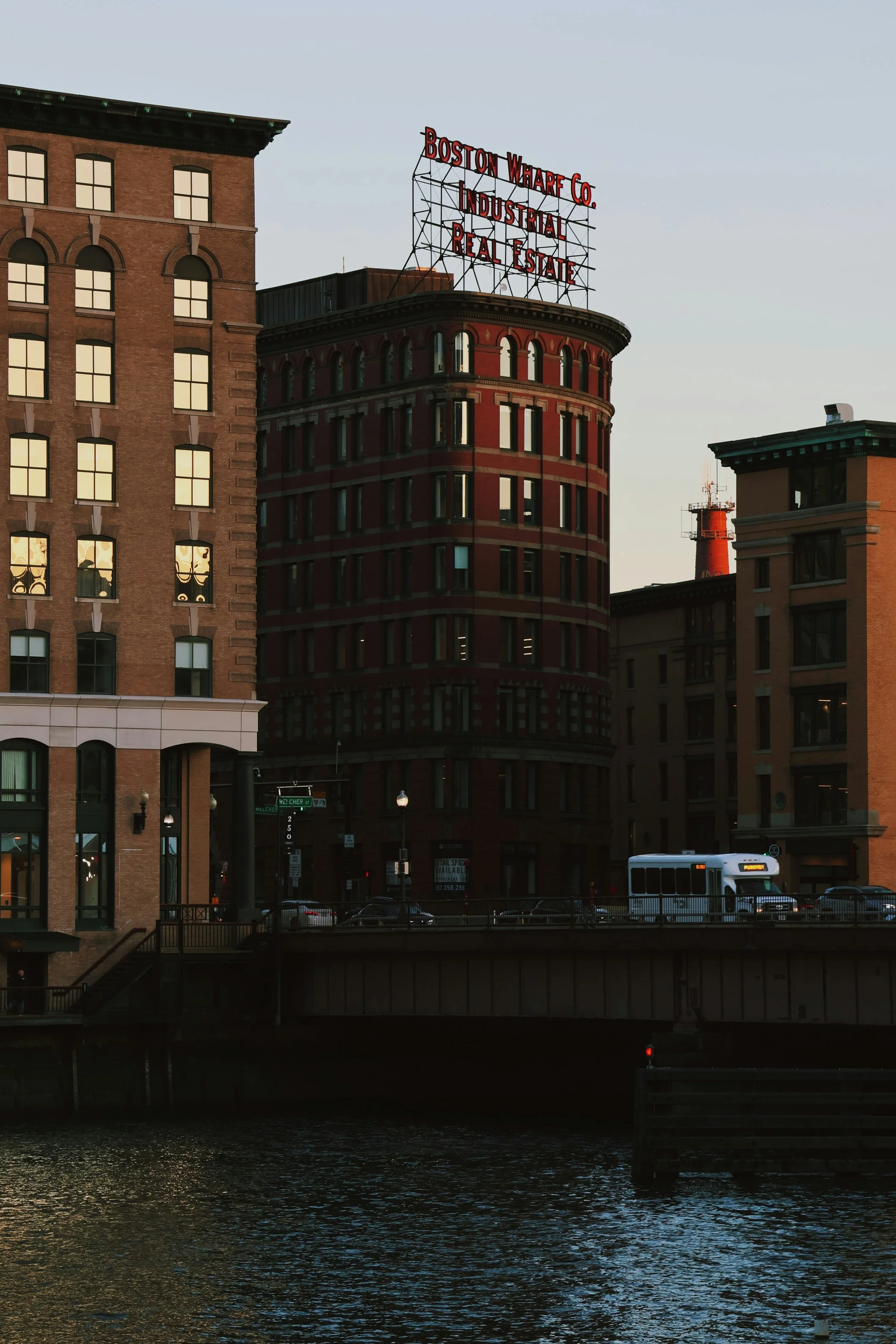 Sunset view of buildings along the Boston Fort Point waterfront.