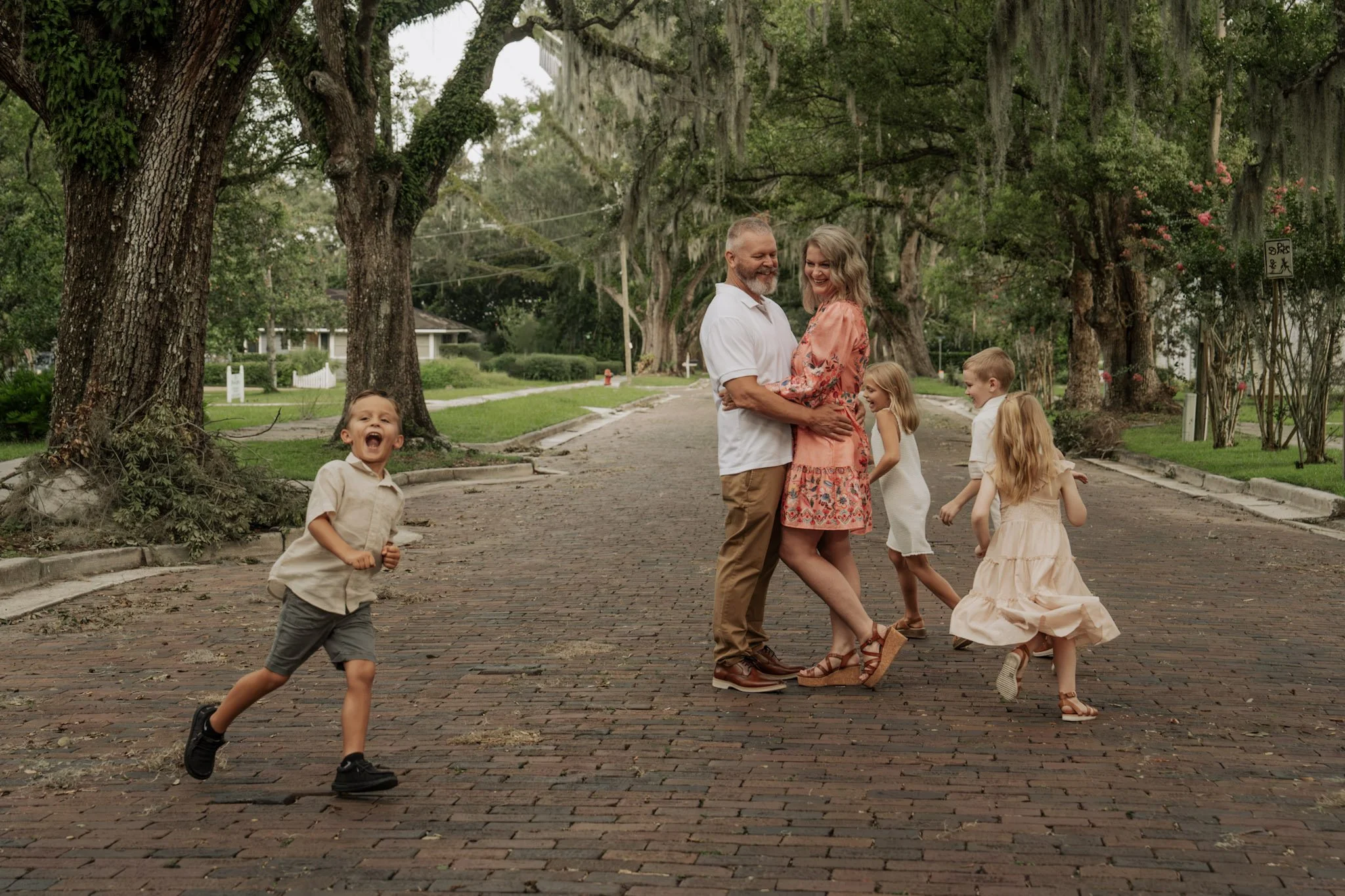 Amy Remling with her family together on a tree-lined street.