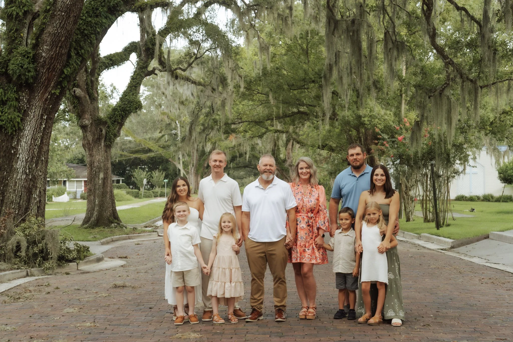 Amy Remling with her family on a tree-lined brick street.