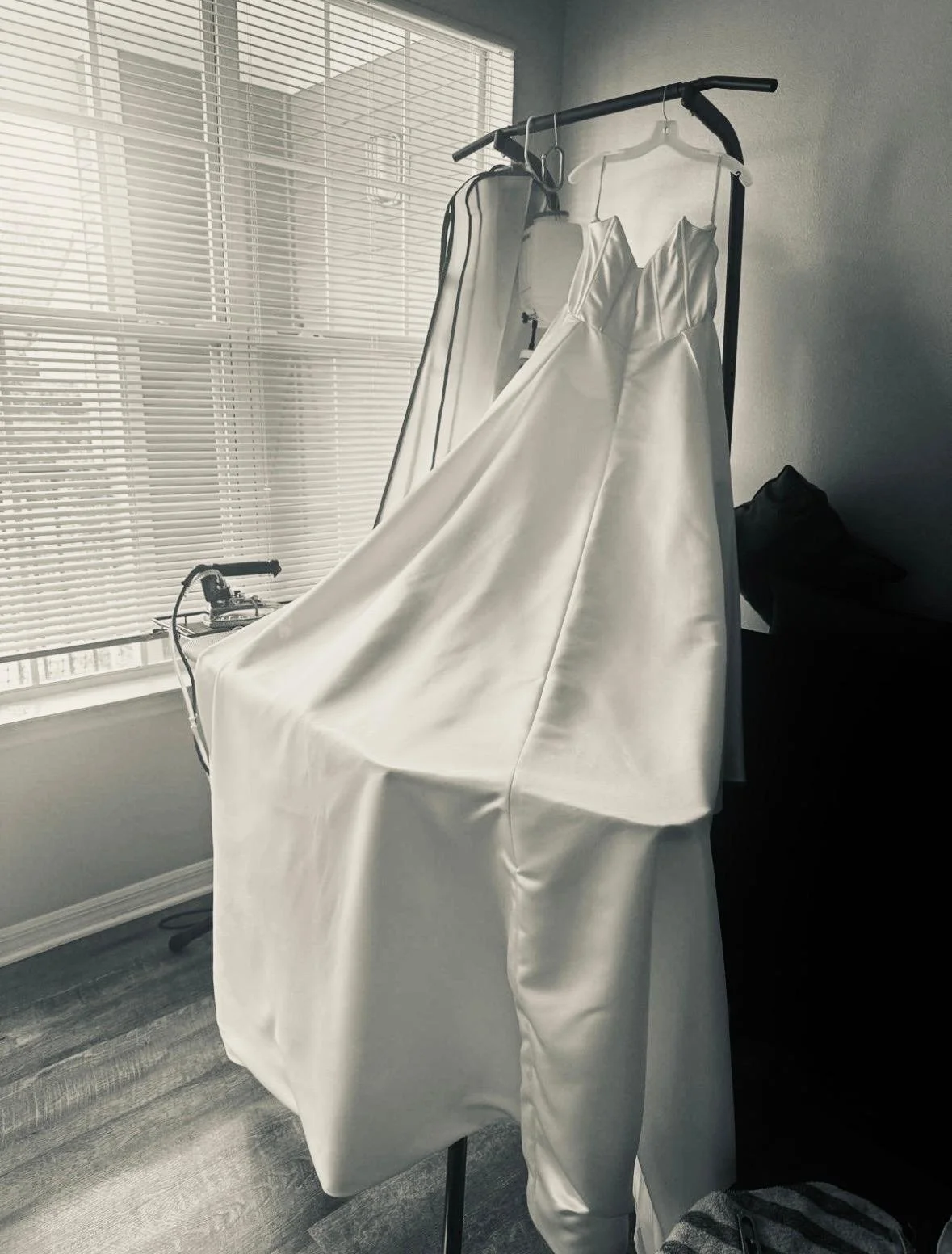 Wedding gown being professionally steamed and prepared for a bridal fitting.