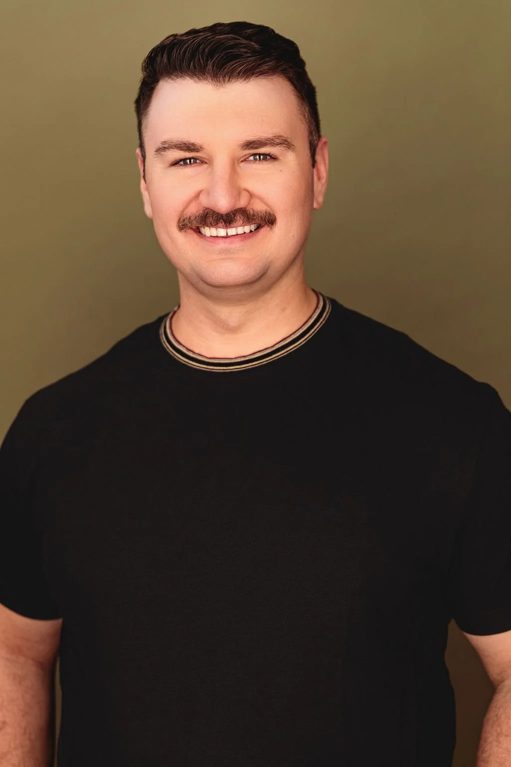 Chris Gallerani - Tenor, smiling in a t-shirt. Headshot by Benjamin Rose Photography.