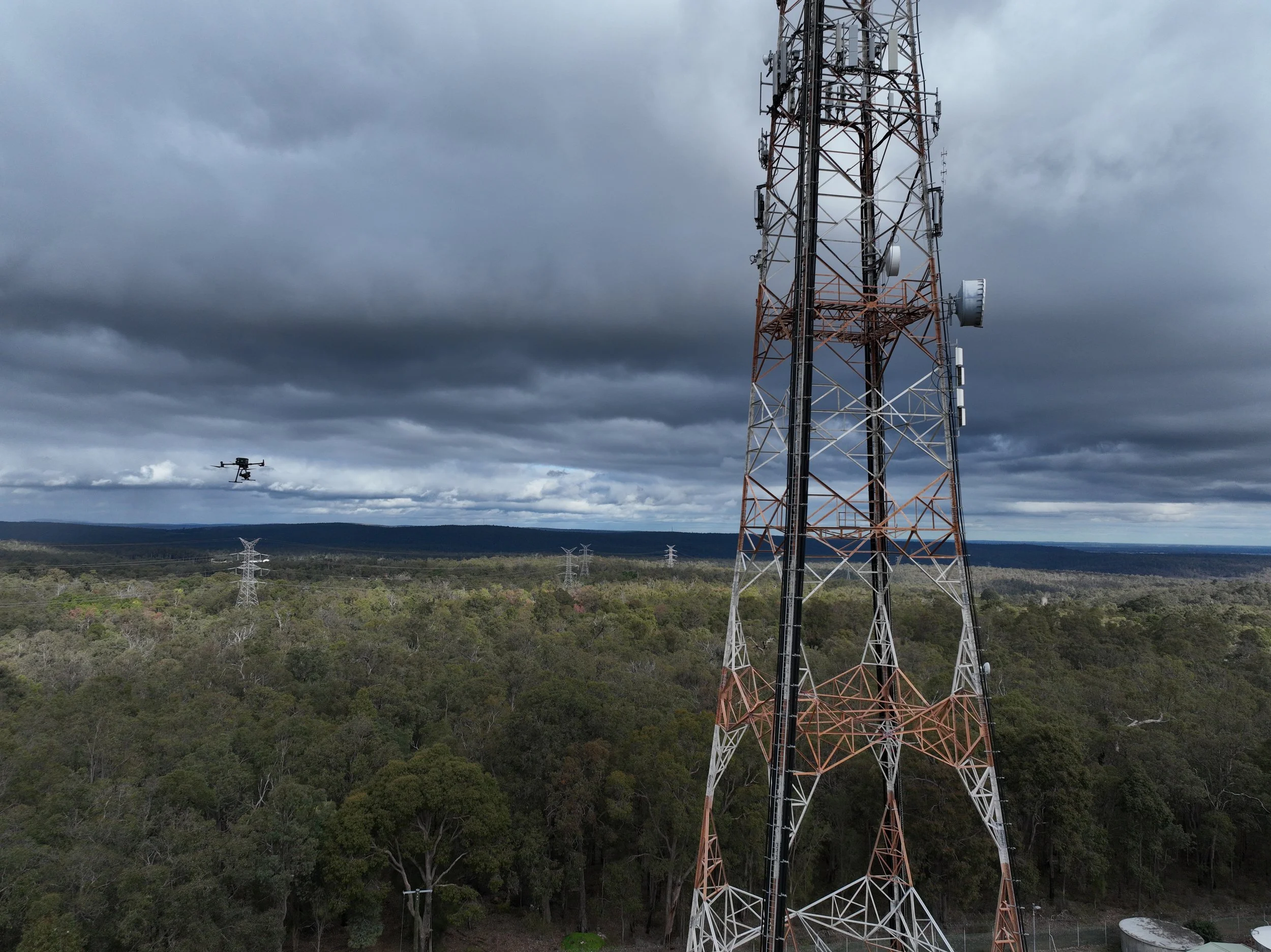 Telecommunications tower documented by drone for a digital twin cost comparison against traditional tower climbing inspections
