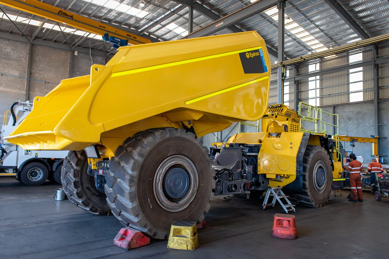 Large mining vehicle photographed inside an industrial workshop