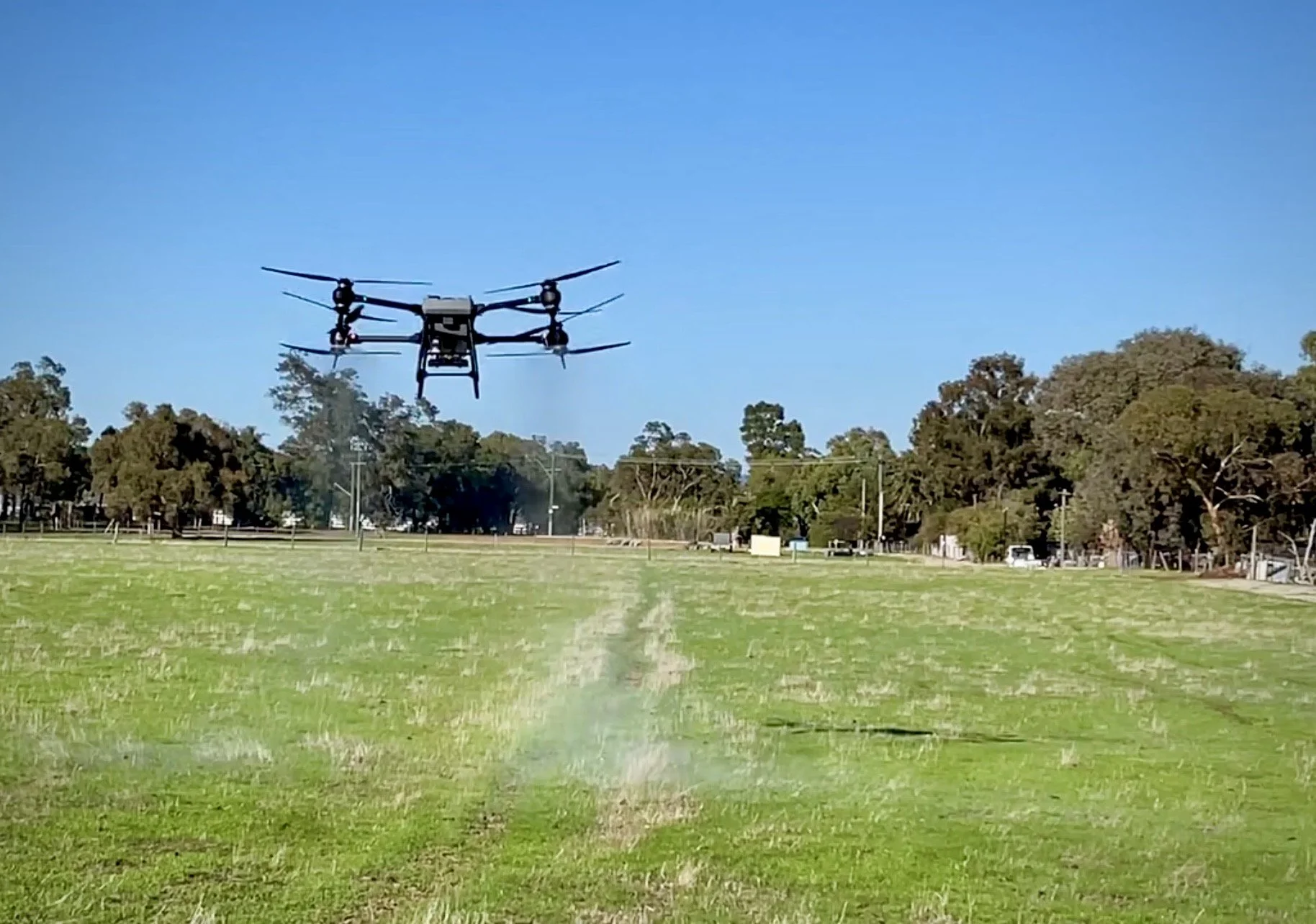 DJI T50 agricultural drone operating over a regional field in Western Australia