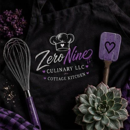 Black apron with Zero Nine Culinary LLC and Cottage Kitchen logo, purple kitchen spatula, whisk, succulent plant, and purple flowers.