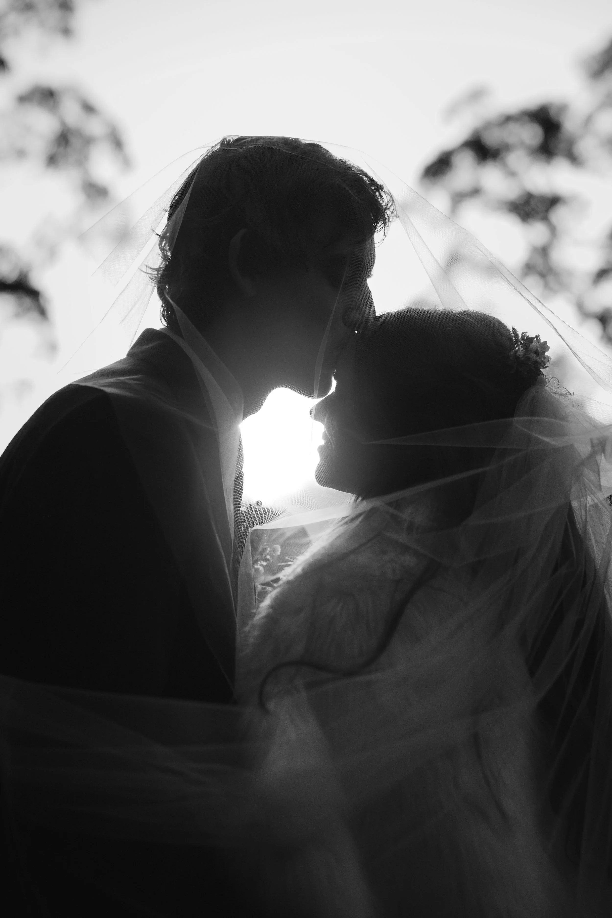 Chloe and Sam sharing a quiet moment beneath the veil at Avalon Castle.