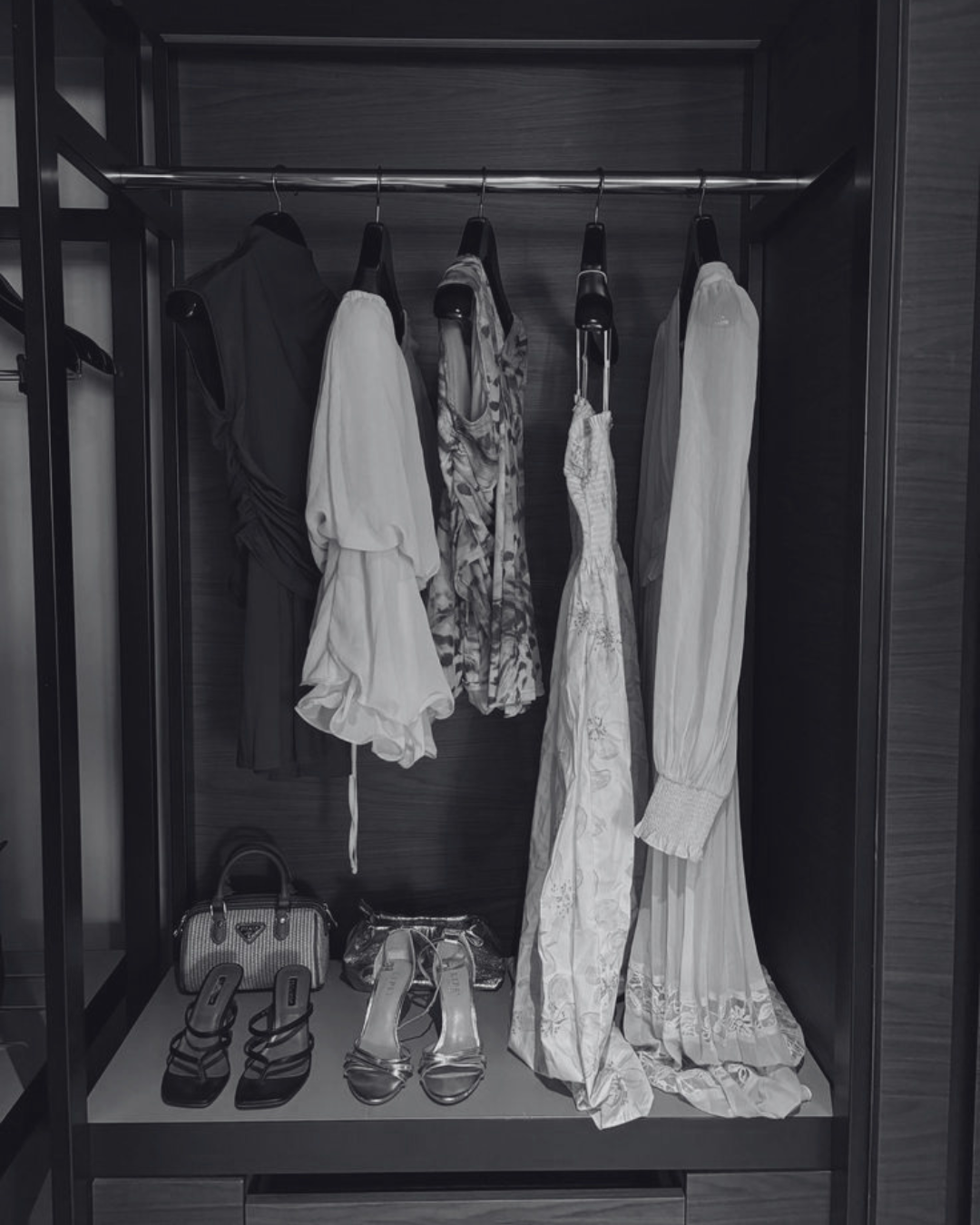 Curated wardrobe of dresses, tops, shoes and handbags in a stylish clothing rack.